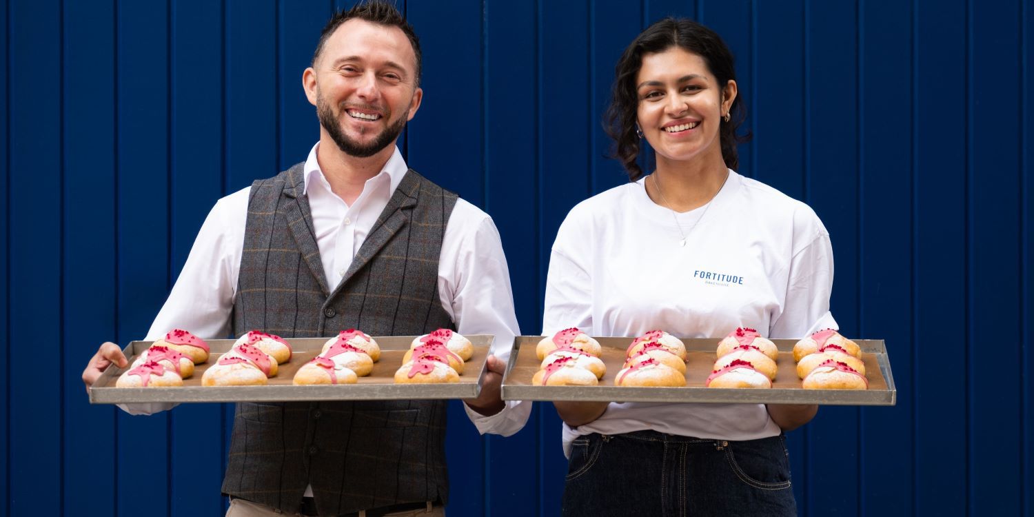 Man and woman holding trays of Kimpton buns