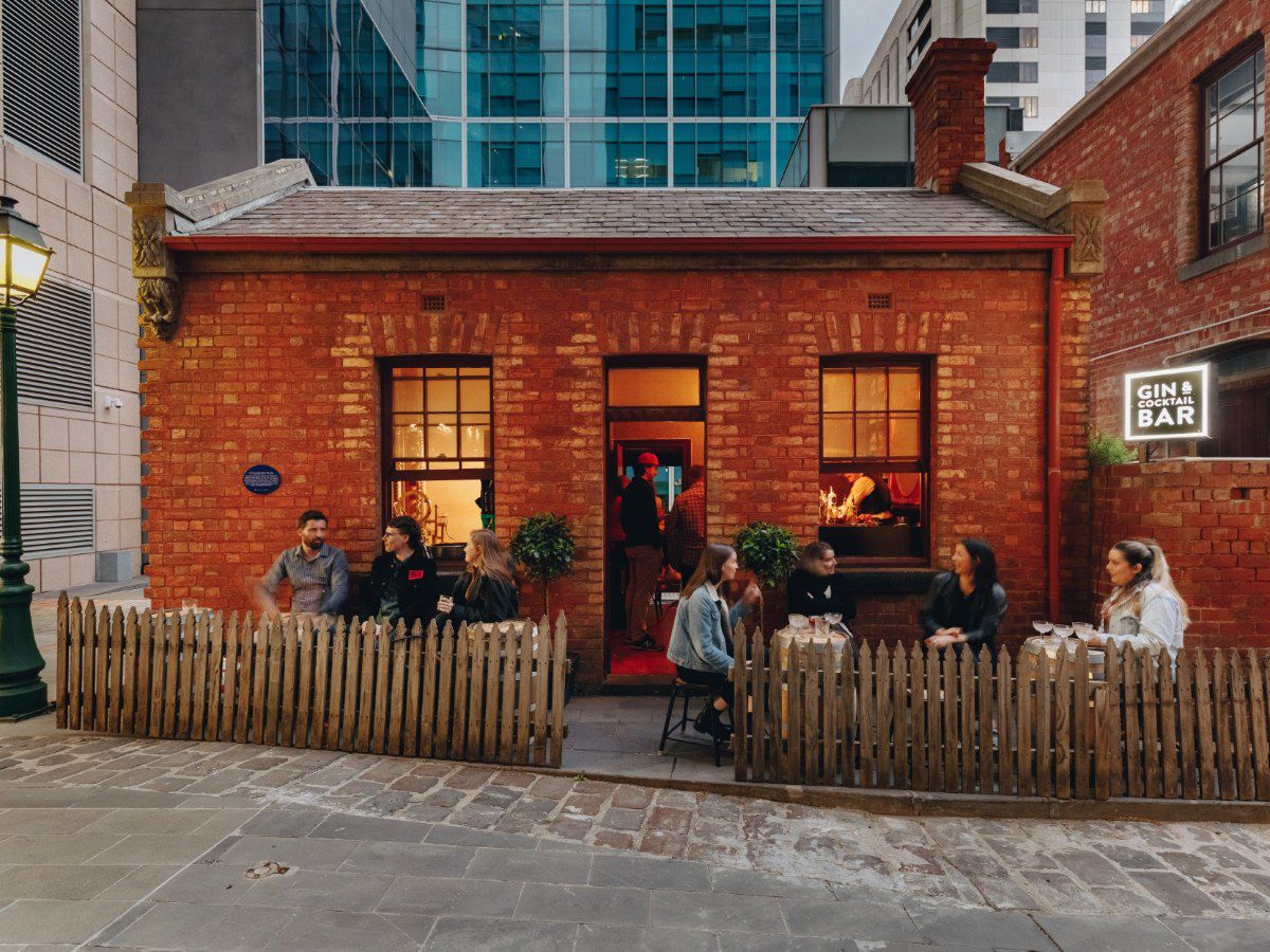 Brick café with outdoor seating and patrons.