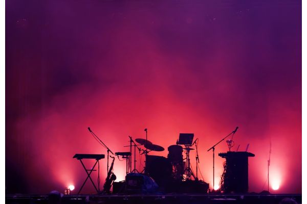 concert stage on rock festival, music instruments silhouettes, colorful background with copy space