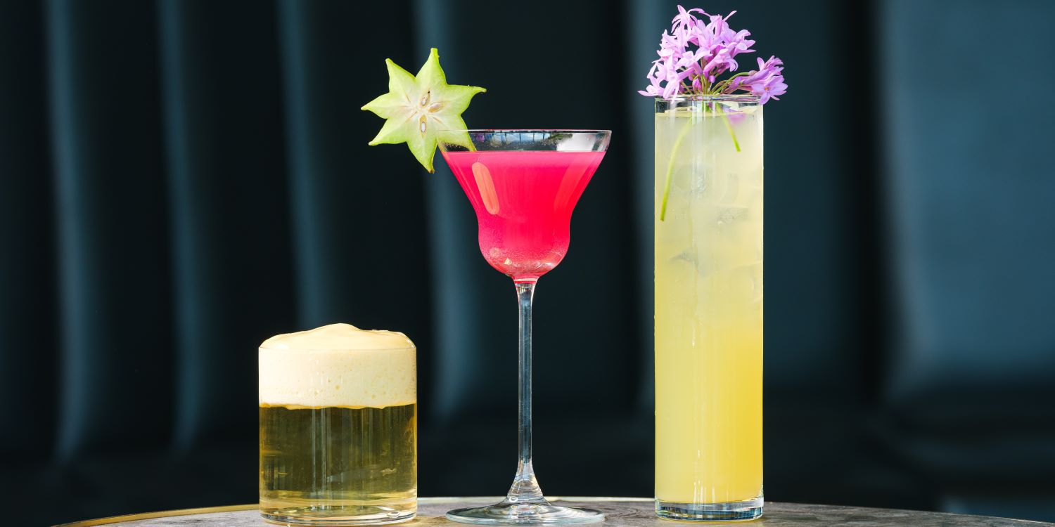 Colourful and cool cocktails lined up on a bar