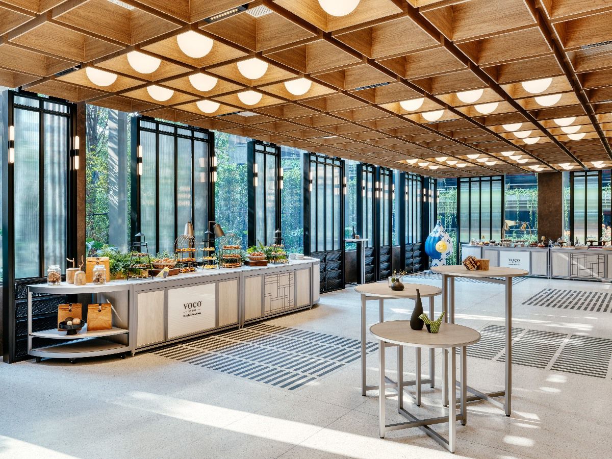 Modern event space with buffet stations and floor-to-ceiling windows.