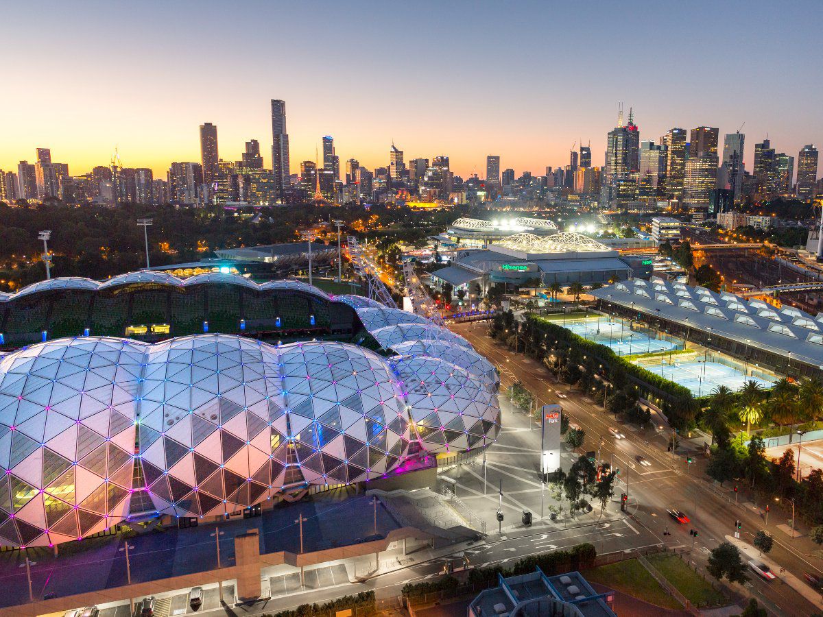 Melbourne sports precinct with illuminated stadiums.