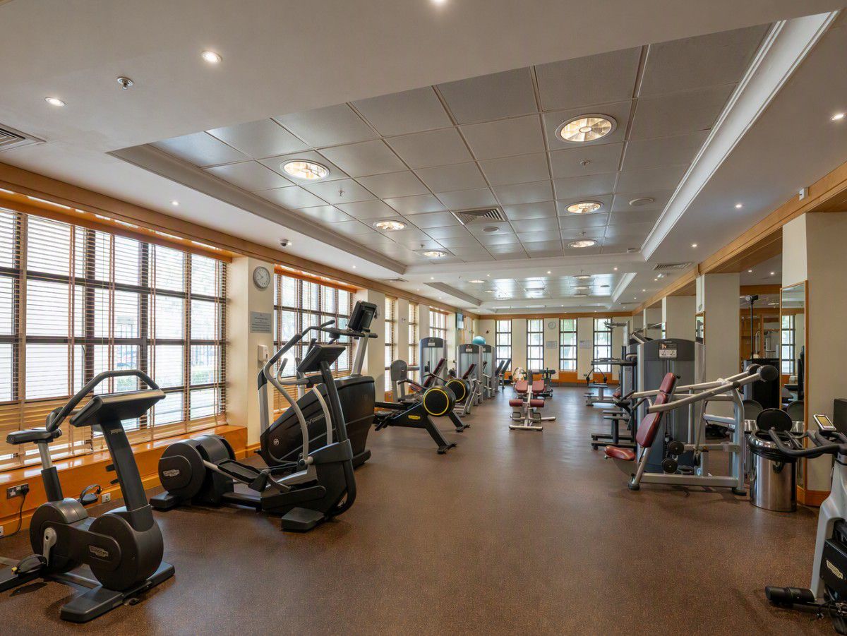 Spacious fitness center with modern exercise equipment indoors