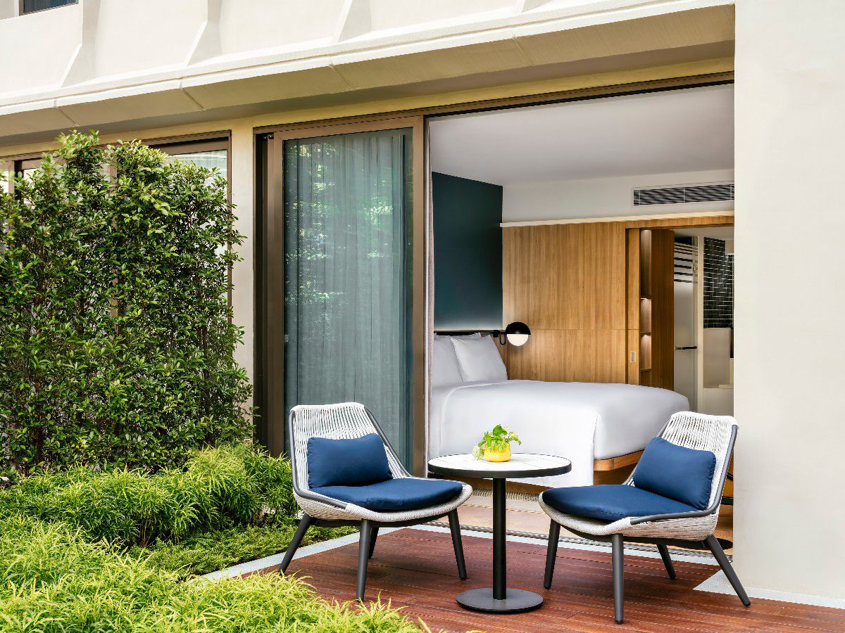 Guest room patio with outdoor seating and garden views.