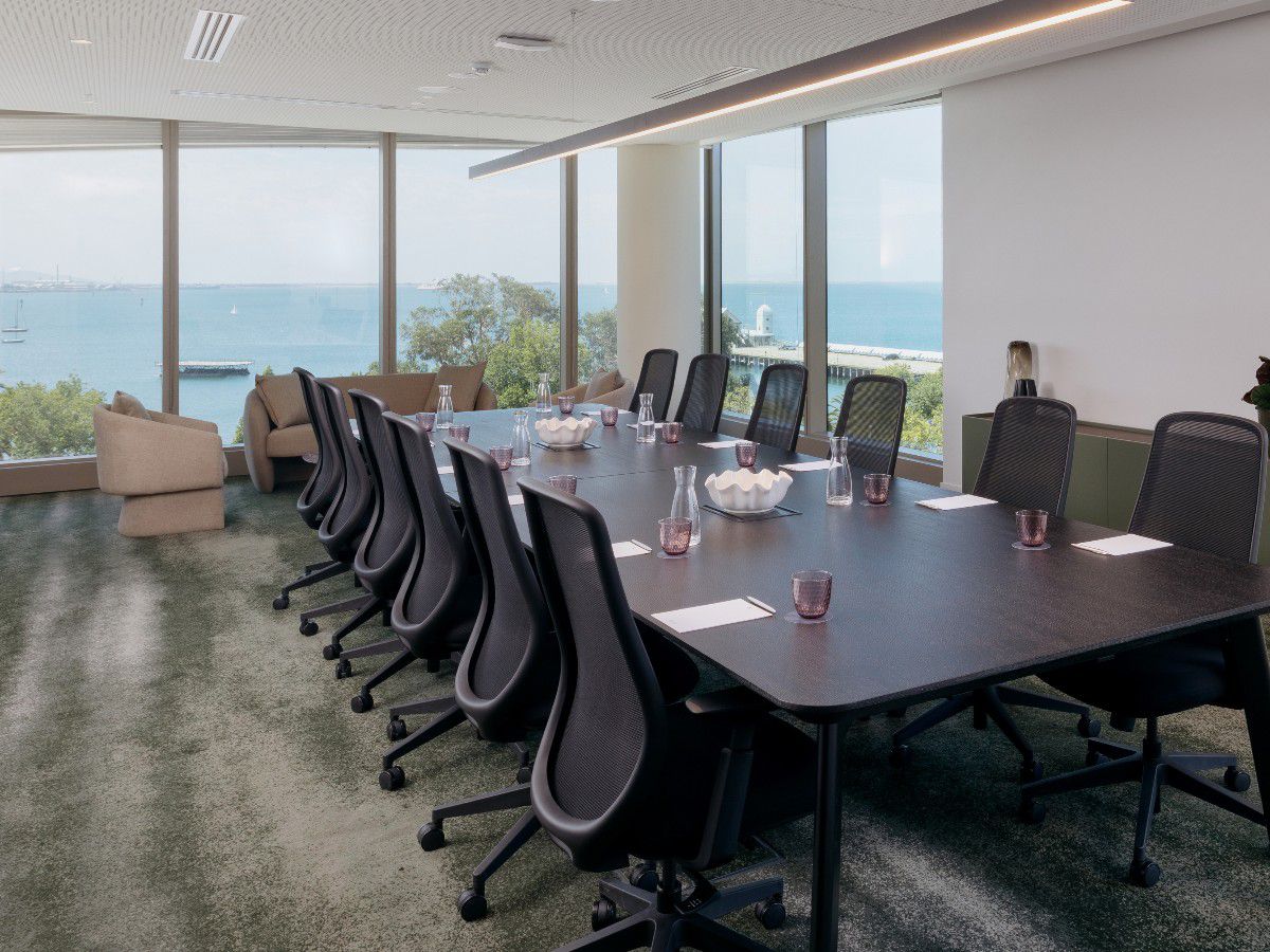 Waterfront meeting room with conference table and ocean views.