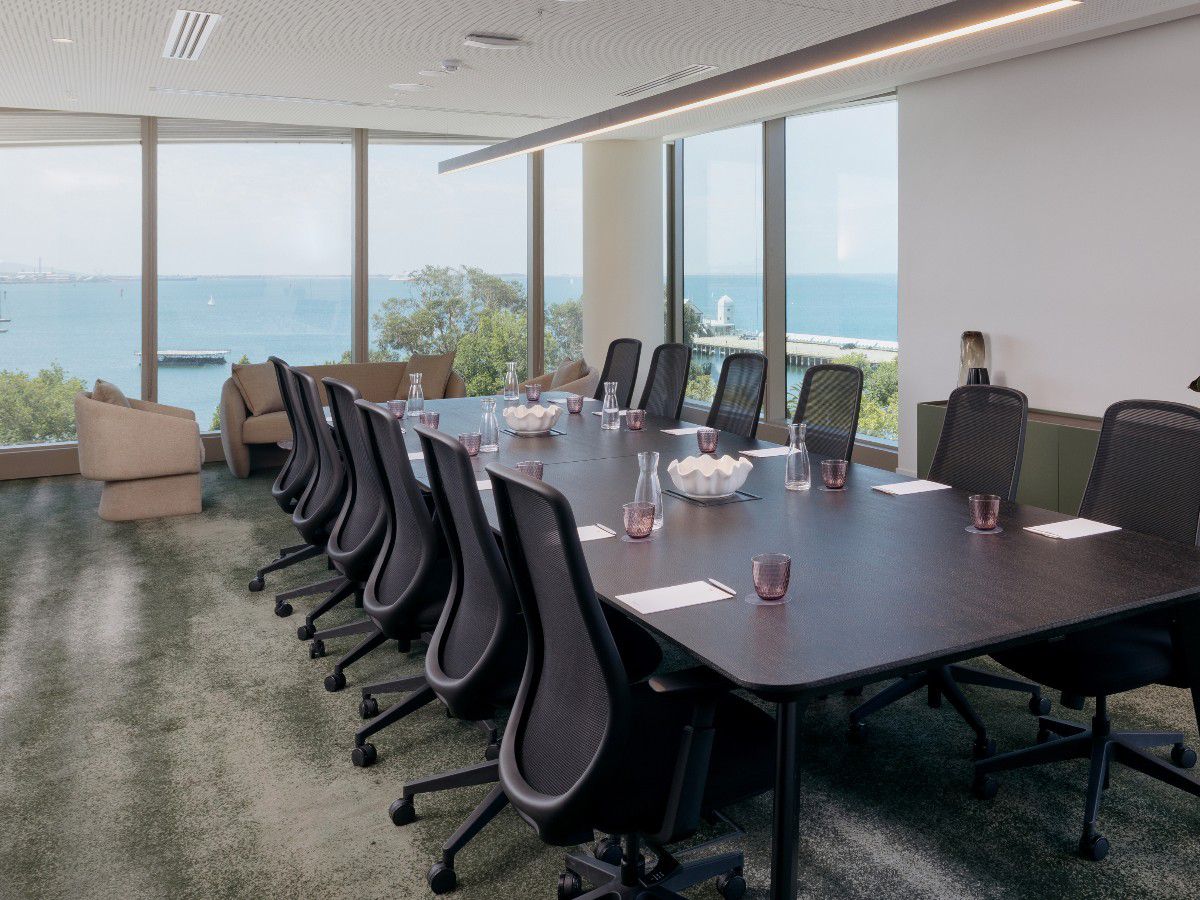 Waterfront meeting room with large conference table.