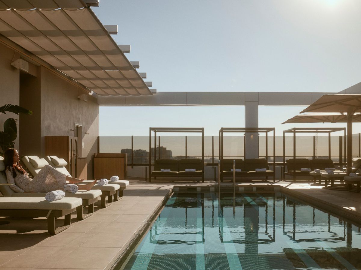 Pool area with loungers and outdoor cabanas