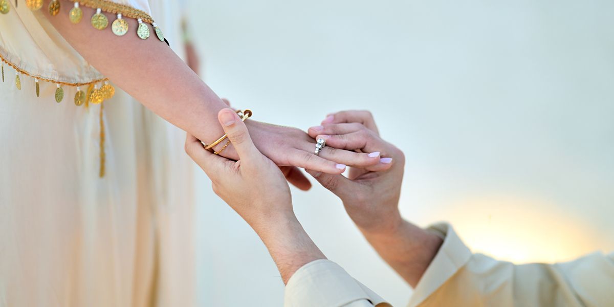 Couple exchanging rings during wedding ceremony.