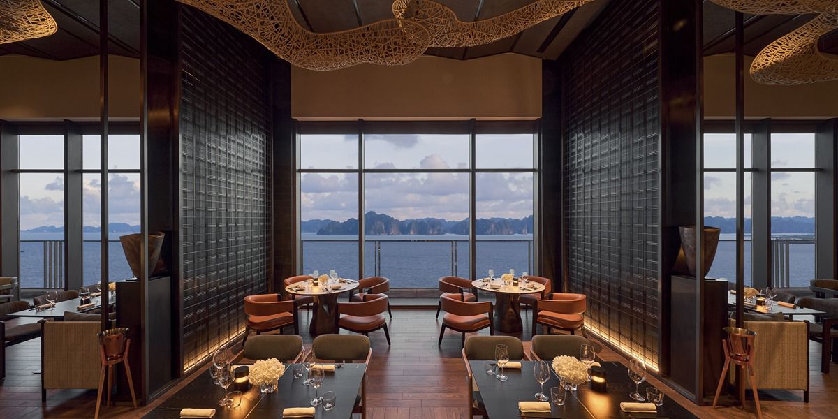 Elegant waterfront restaurant dining room with panoramic mountain views