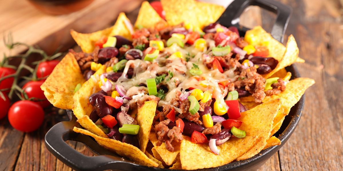 Loaded nachos with beans, cheese, corn, and peppers