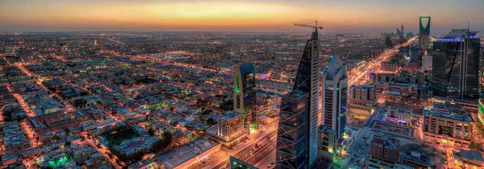 High Angle View Of Illuminated Cityscape Against Blue Sky During Sunset