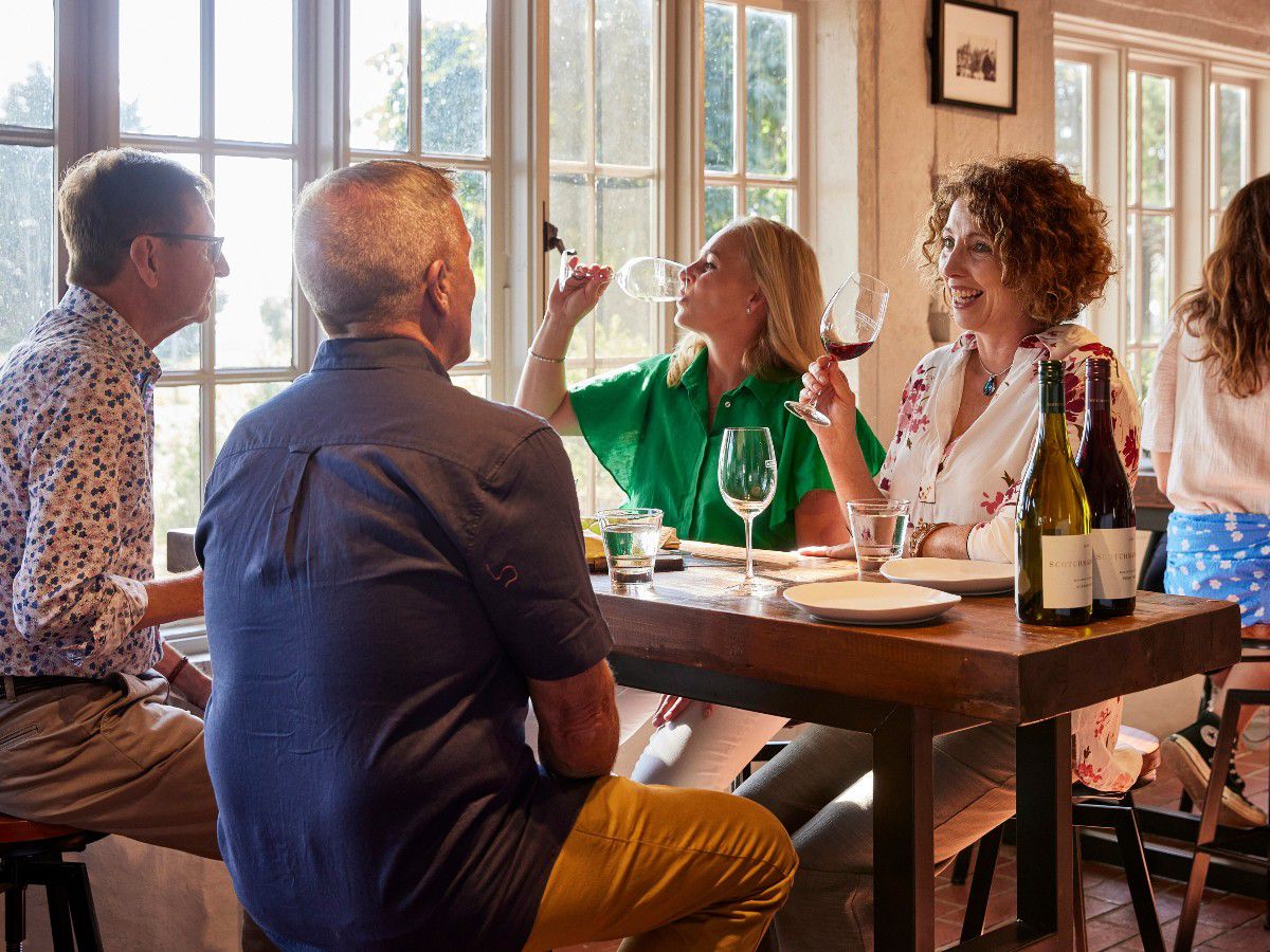 People enjoying wine together at a winery restaurant.