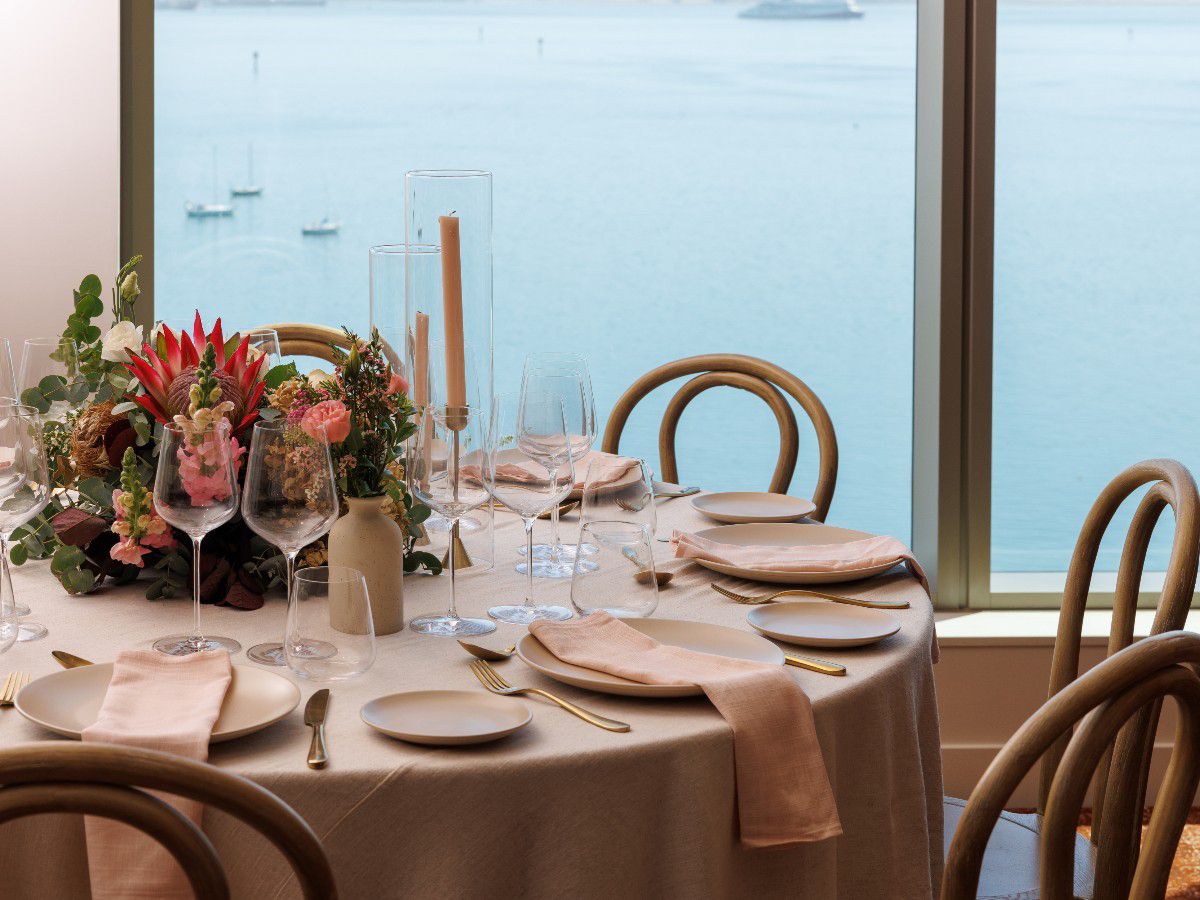 Elegant waterfront dining table with floral centerpiece.