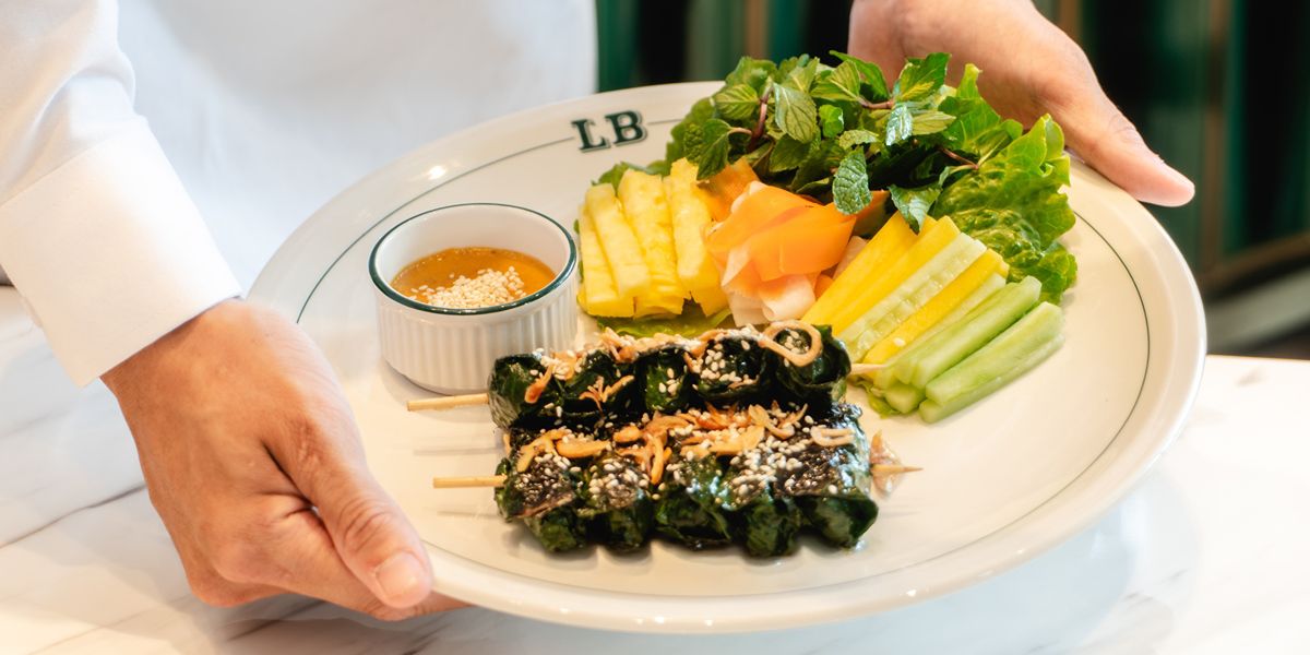 Vietnamese grilled skewers with fresh vegetables and dipping sauce