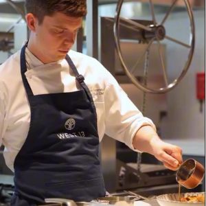 Chef preparing a dish in a restaurant kitchen