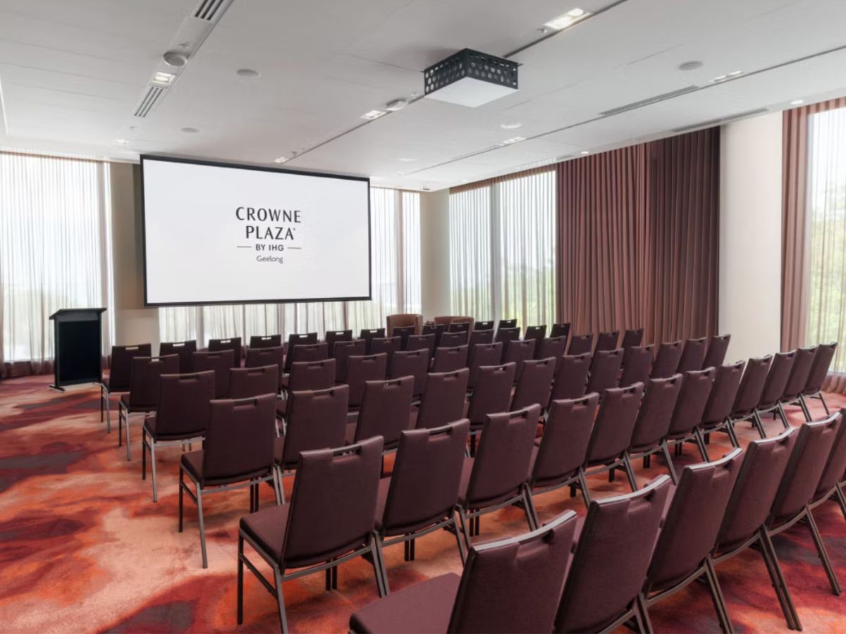Conference room with presentation screen and theater seating.