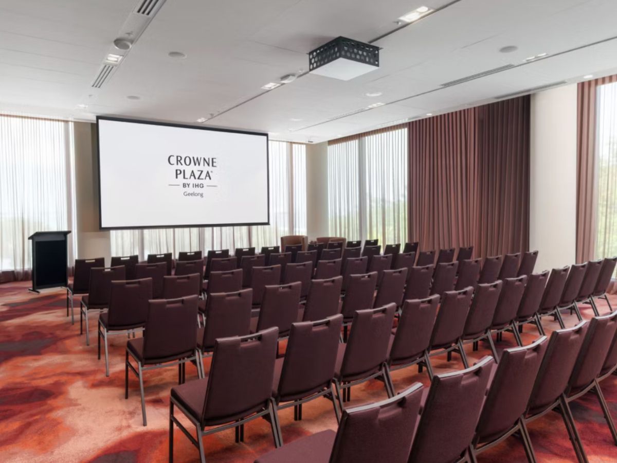Conference room with presentation screen and seating.