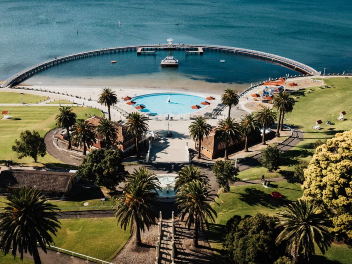 Aerial view of waterfront pool and pier.