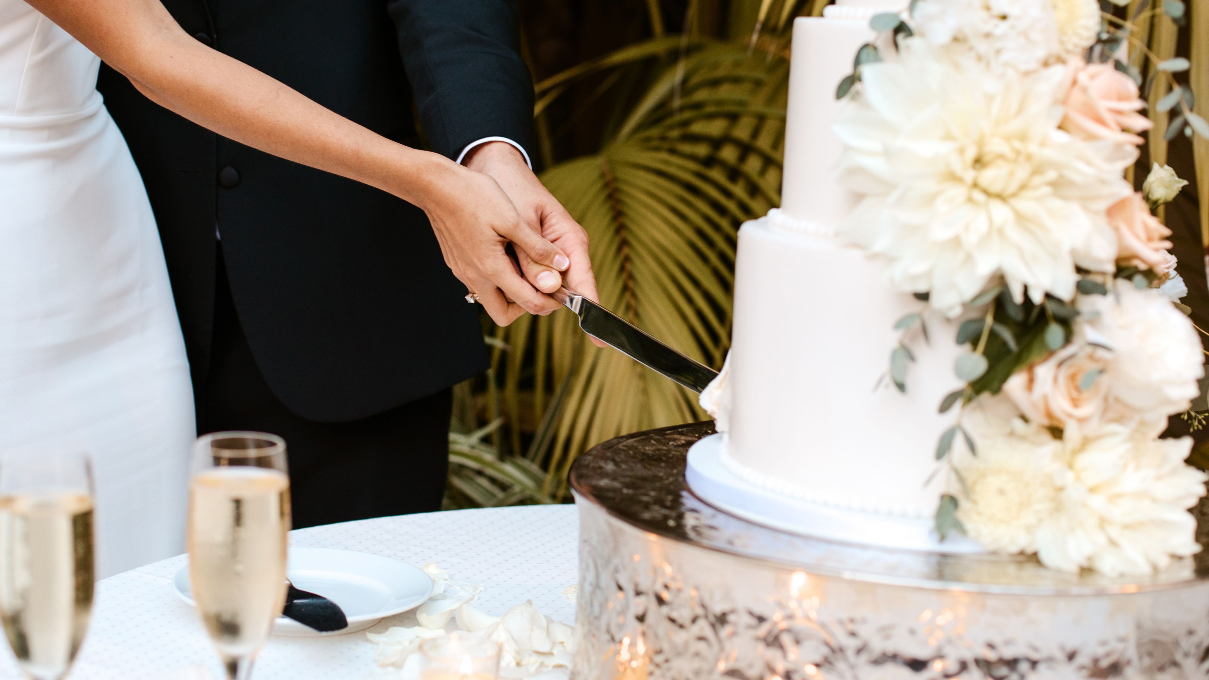 Wedding reception table featuring white and green florals