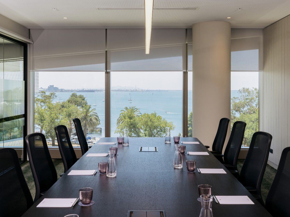 Waterfront meeting room with ocean views and conference table.