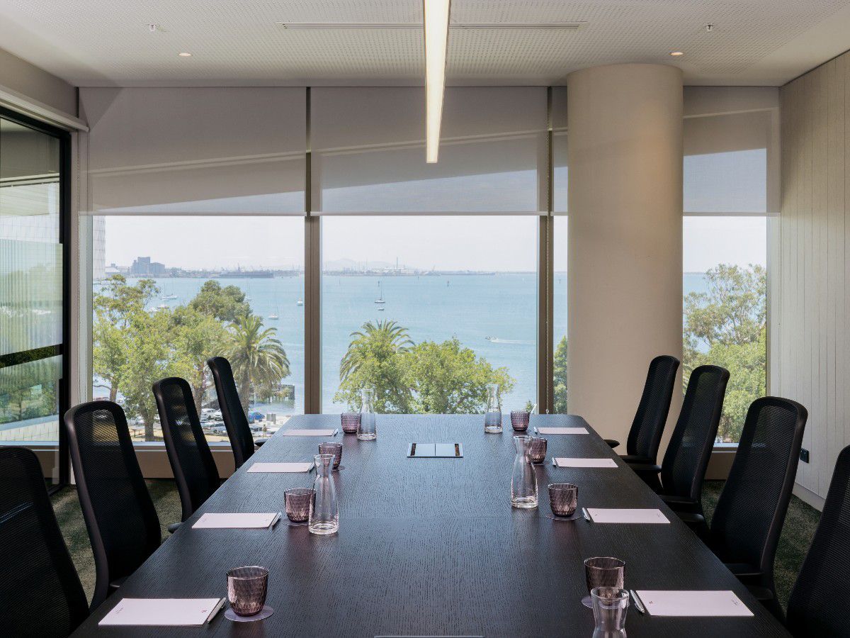Conference room with waterfront views and table seating.