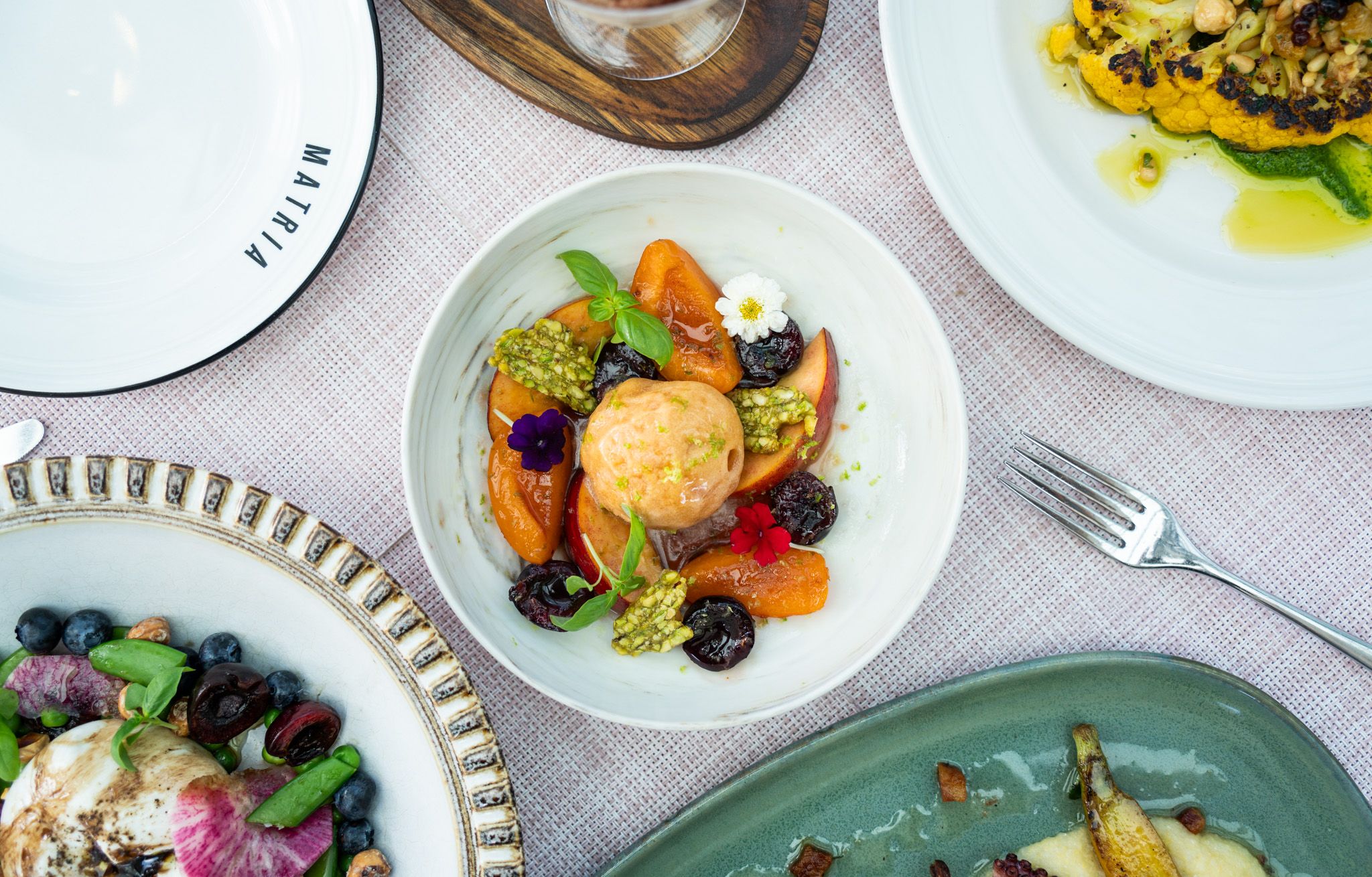 seasonal menu item featuring colorful fruit and florals