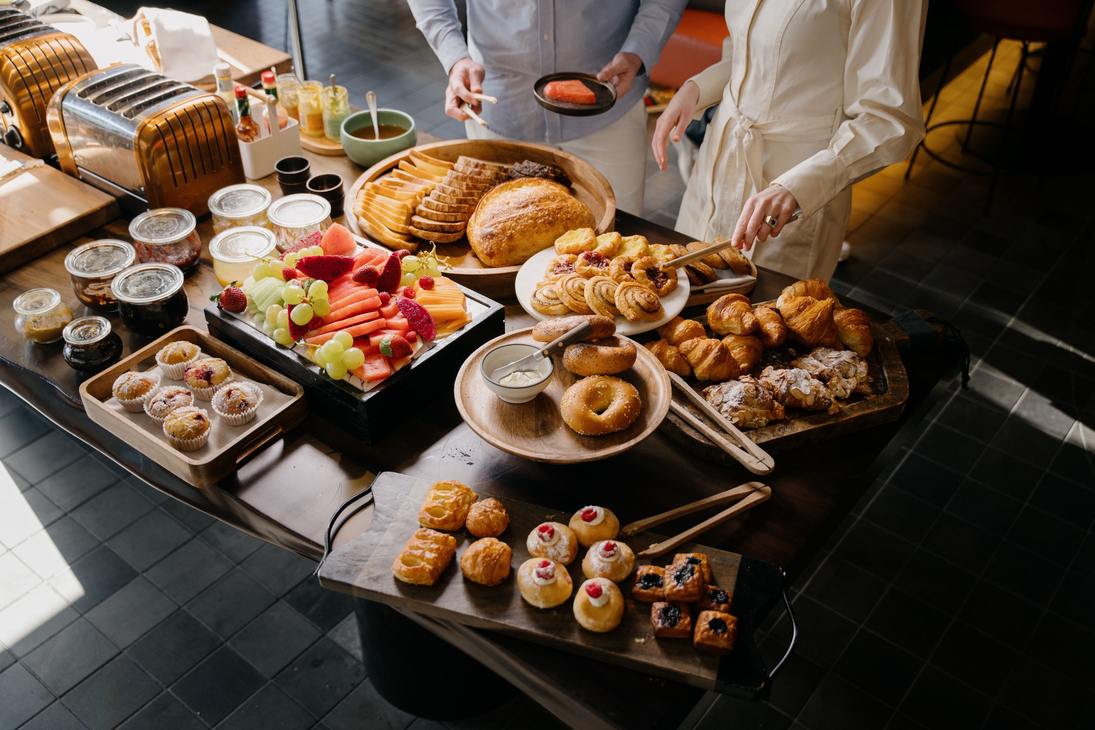 Breakfast buffet at Advieh, featuring pastries, fruit, and jams.