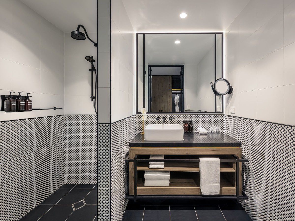 Modern bathroom with vanity, mirror, and shower.