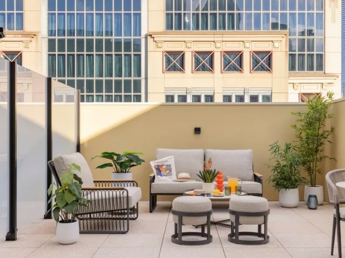 Modern outdoor terrace with comfortable lounge and greenery