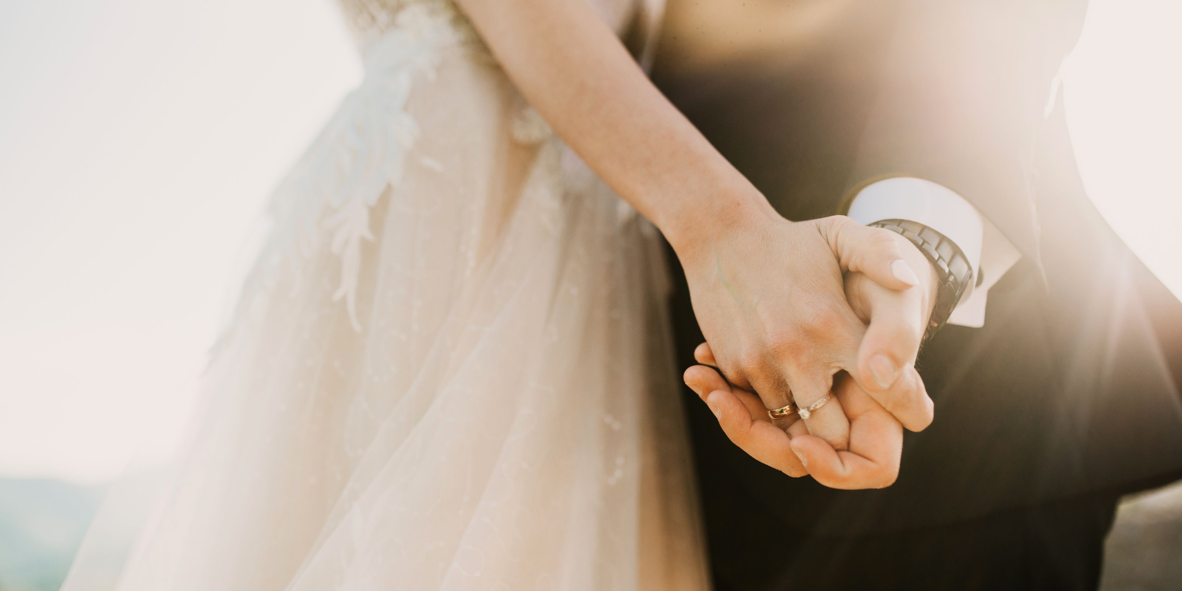 bride and groom holding hands