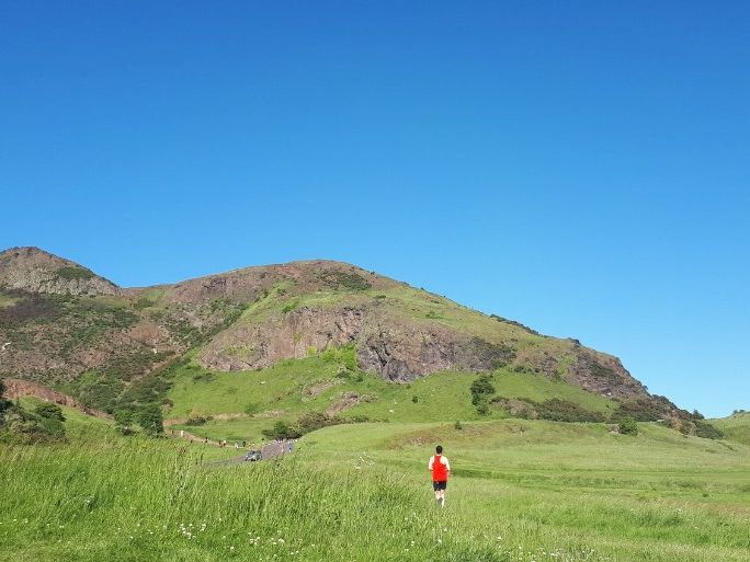 Man running through Arthurs Seat
