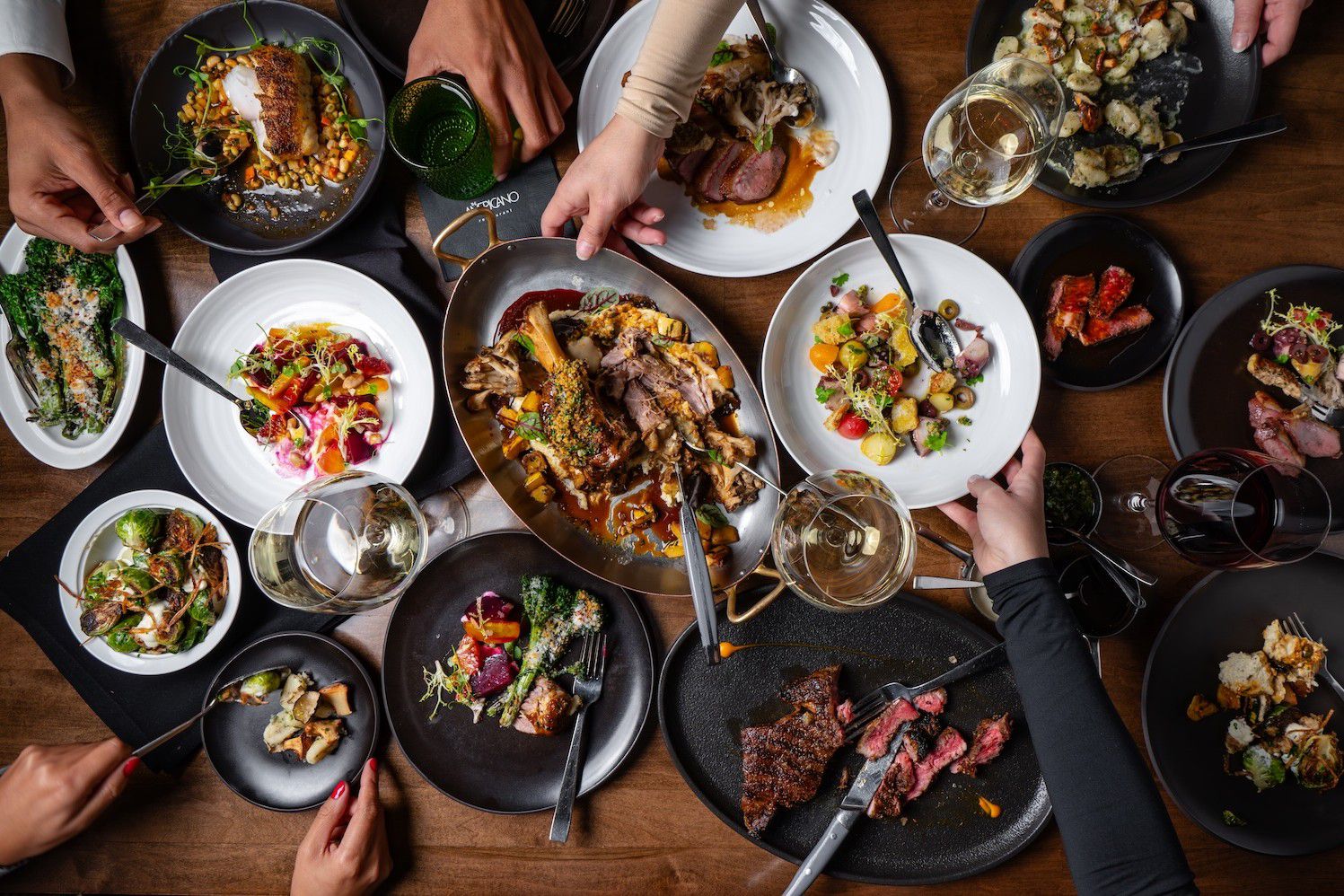 Holiday dining spread featuring festive appetizers, entrées, and side dishes.