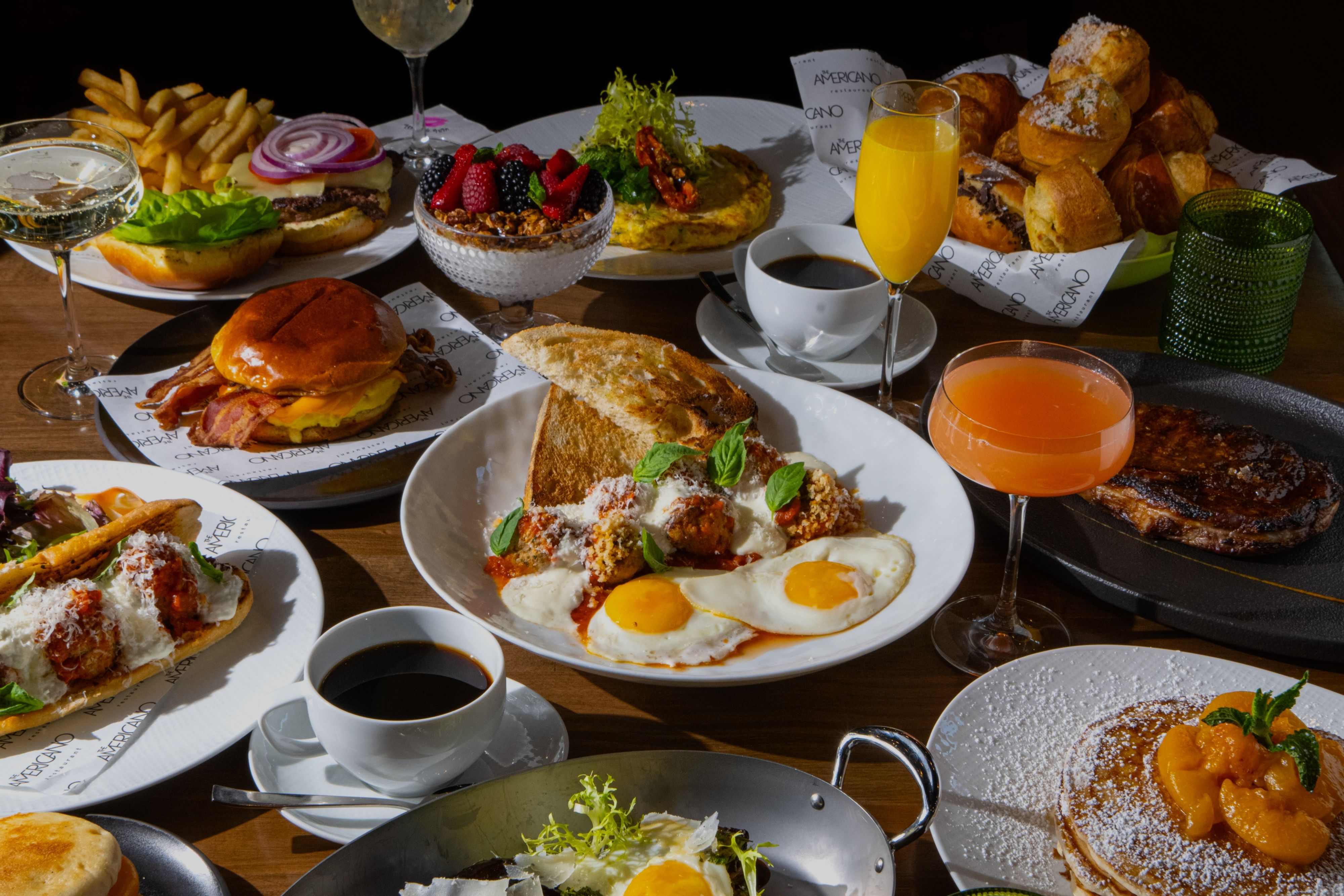 Brunch table filled with shared plates, fresh fruit, and breakfast favorites.