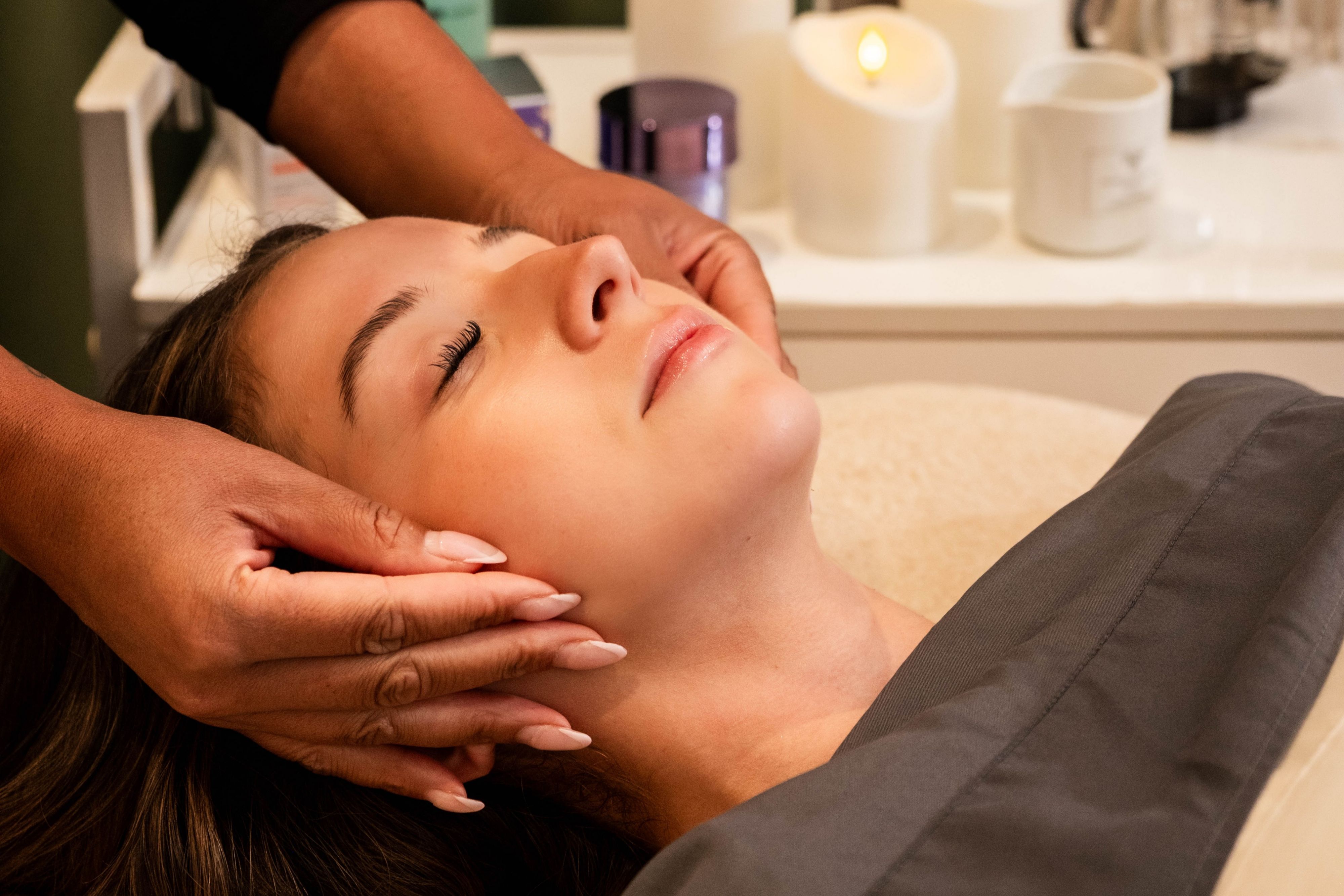 Spa guest receiving a facial massage during a treatment