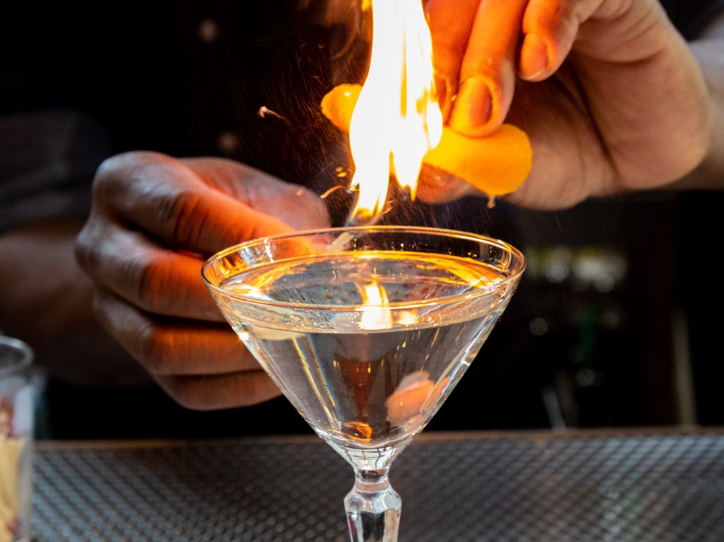 Bartender making martini with a flame