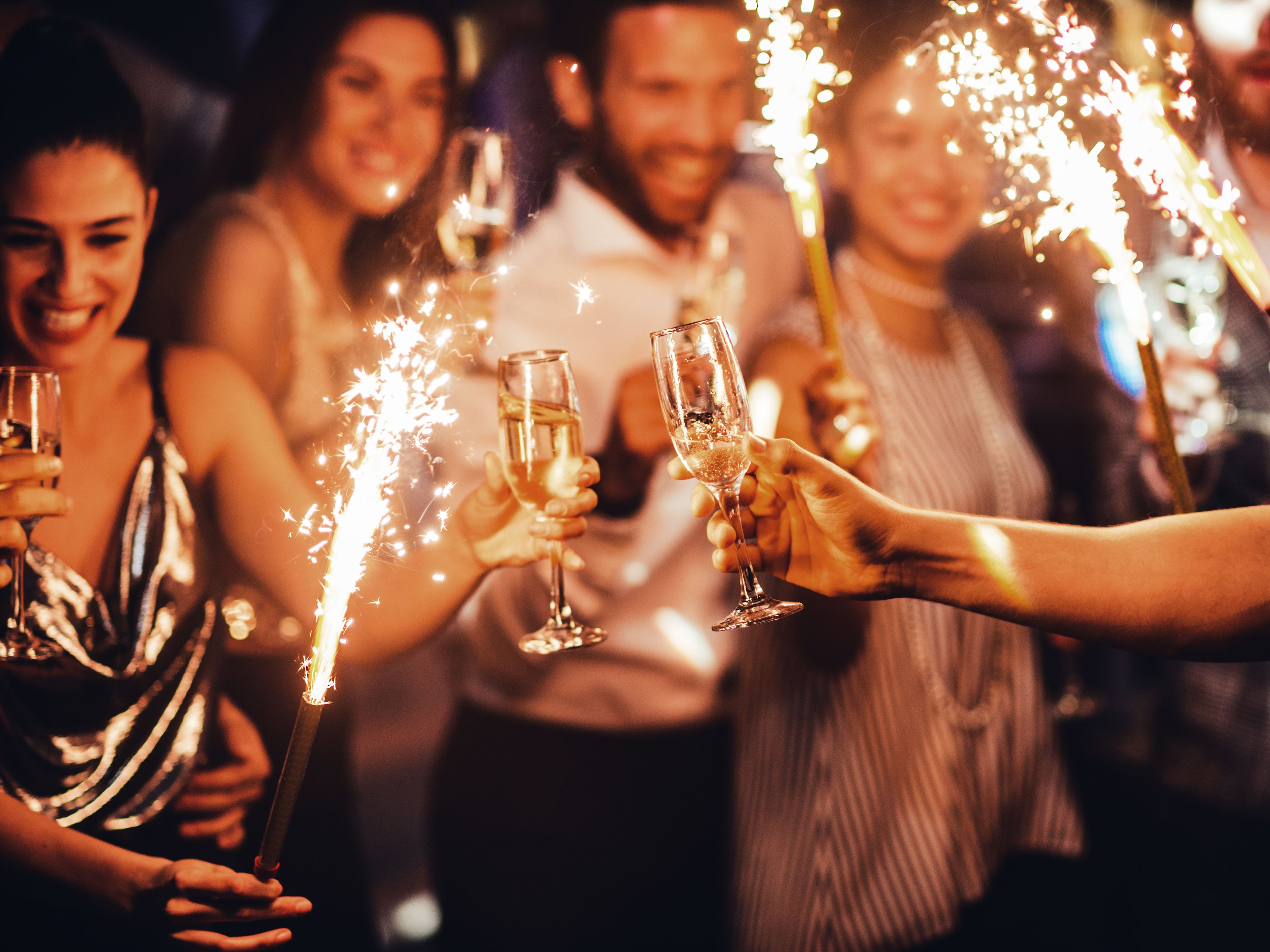 Friends celebrating New Years Eve with sparklers and champagne