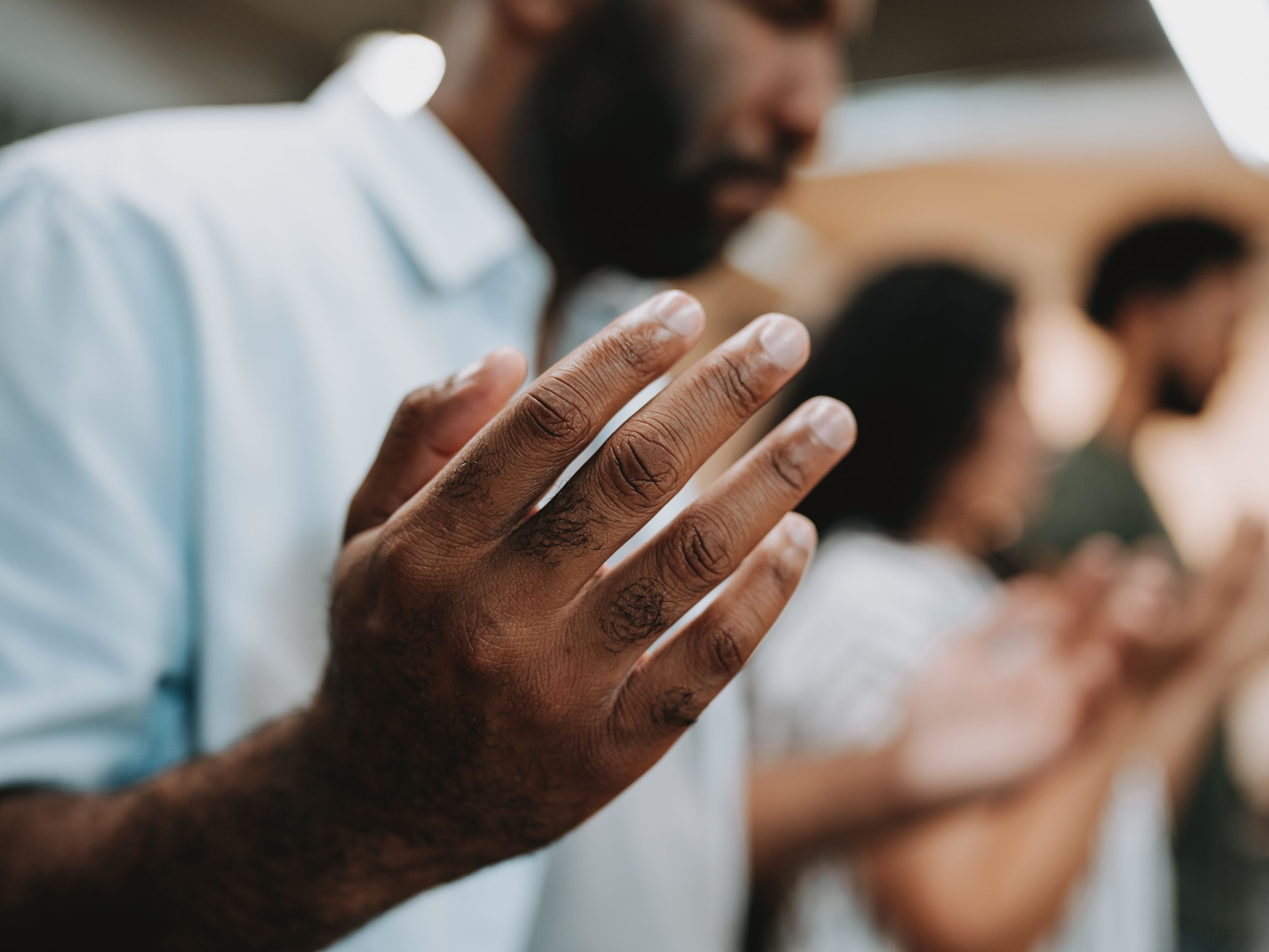 man with hands raised