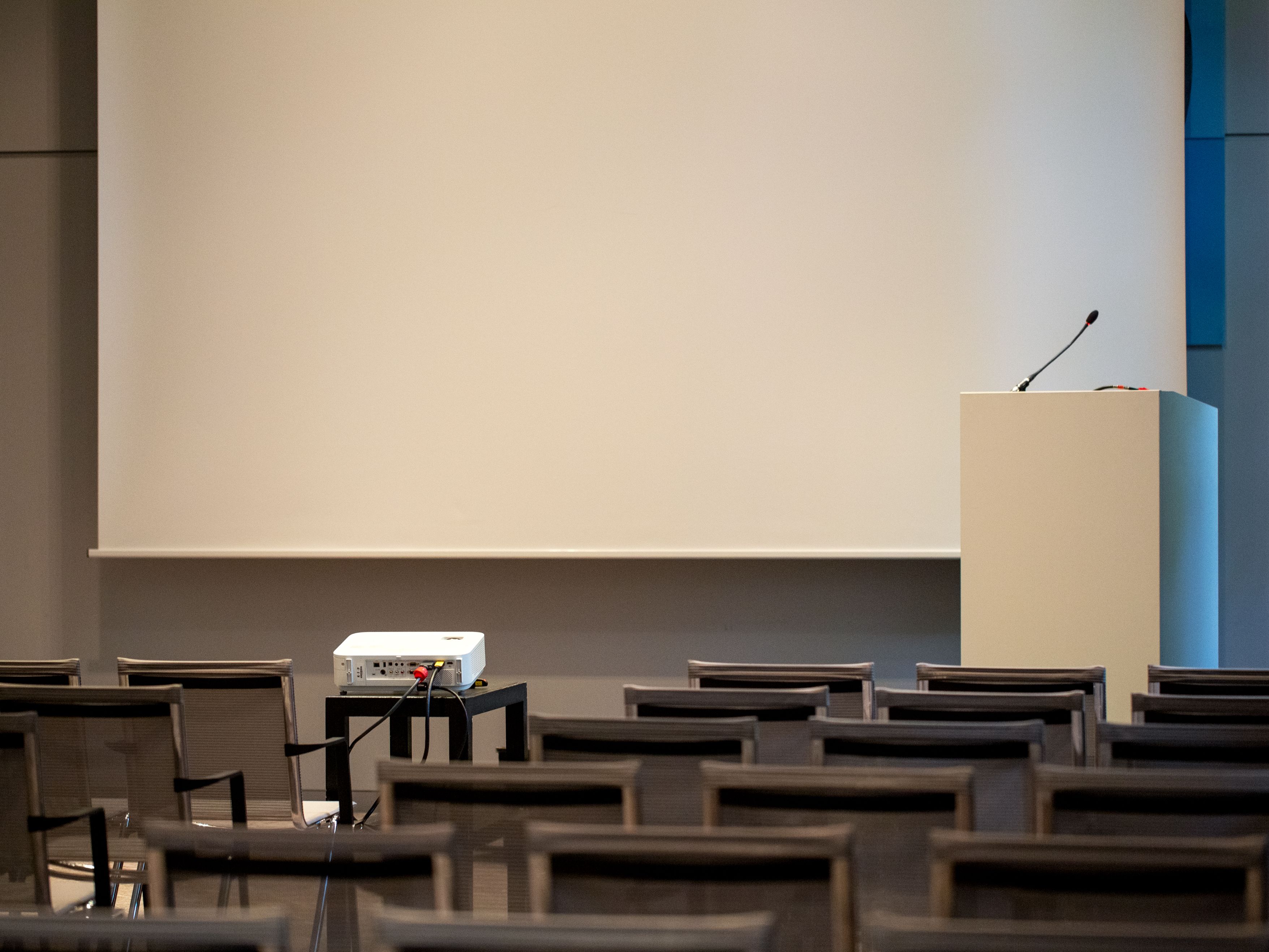 empty classroom with projector screen and seats