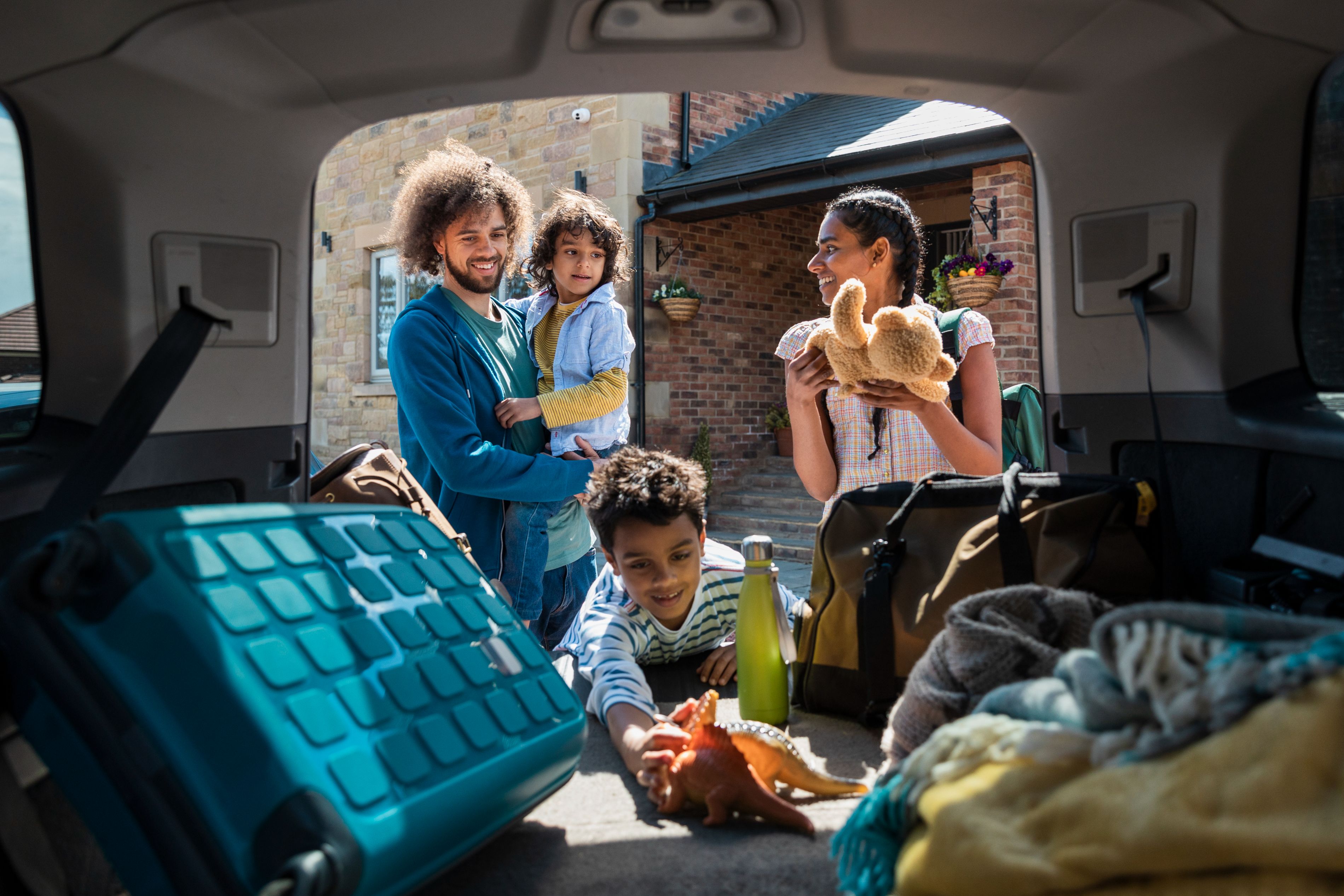 family packing a car for a trip