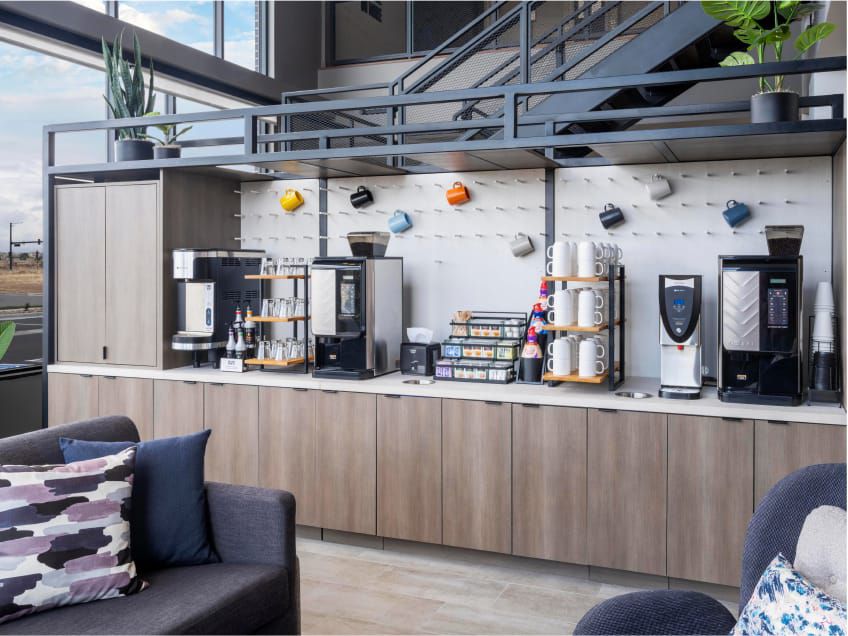 Downstairs lobby seating area near a beverage station with self-serve coffee, tea and more.