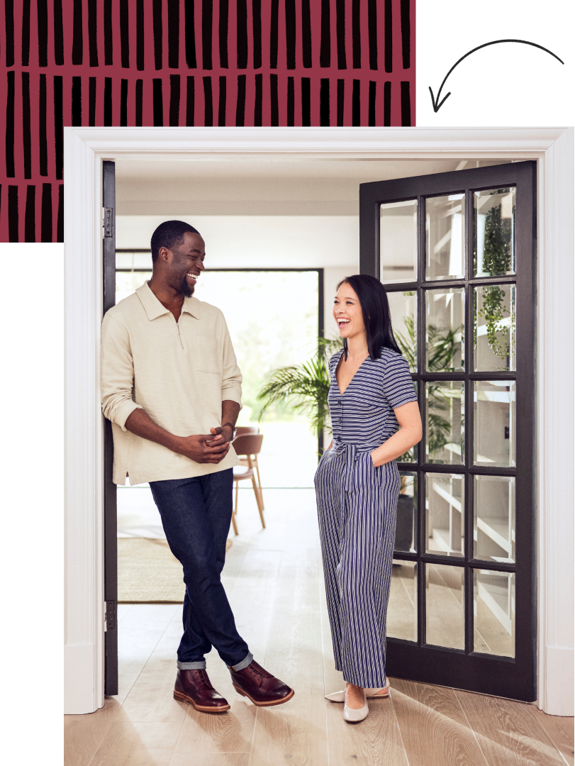 Man and woman casually talking in an ornate door frame.