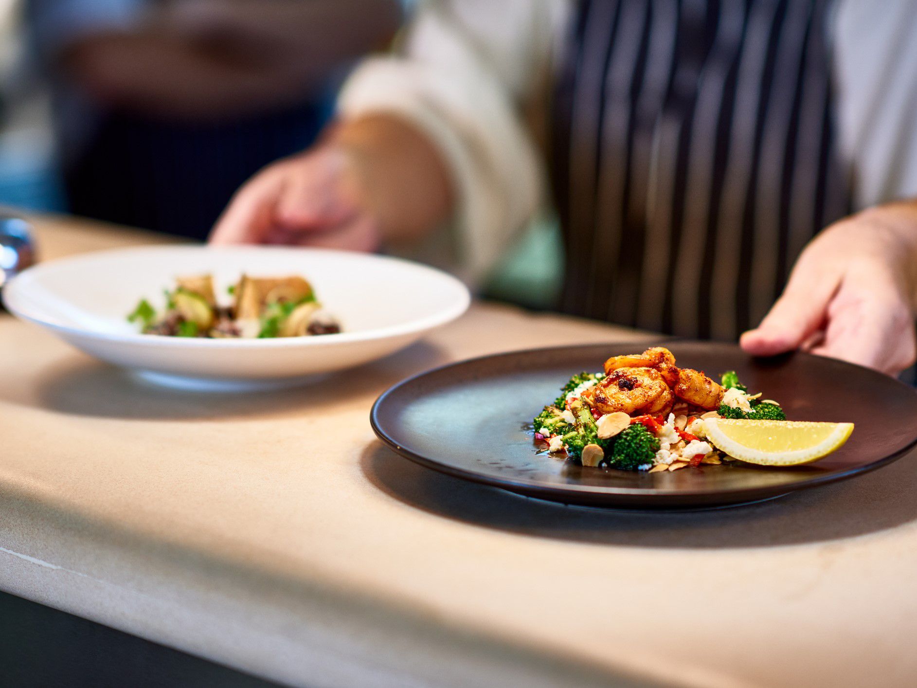 Chef placing dishes on the line