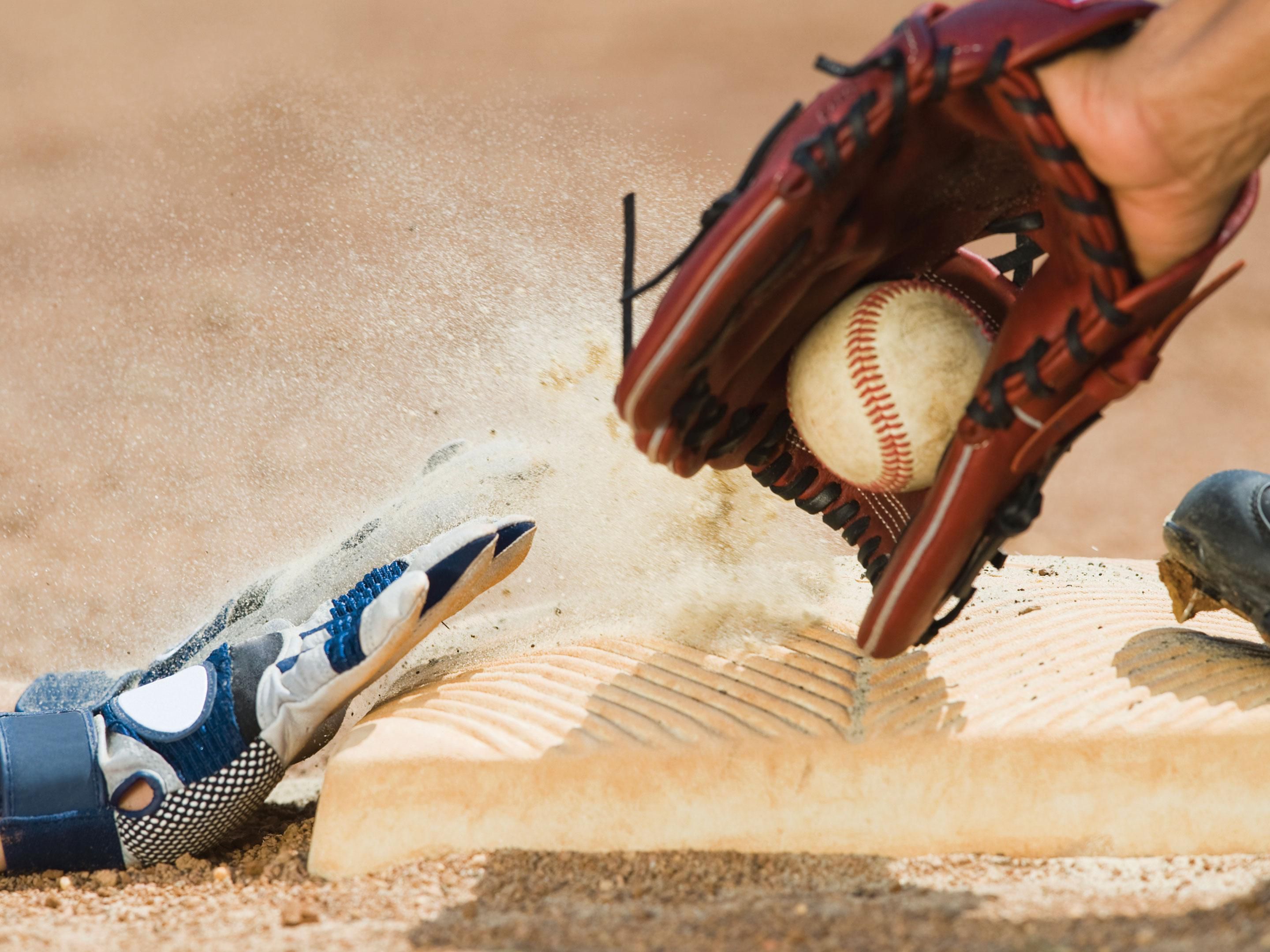 Baseball player sliding into a base