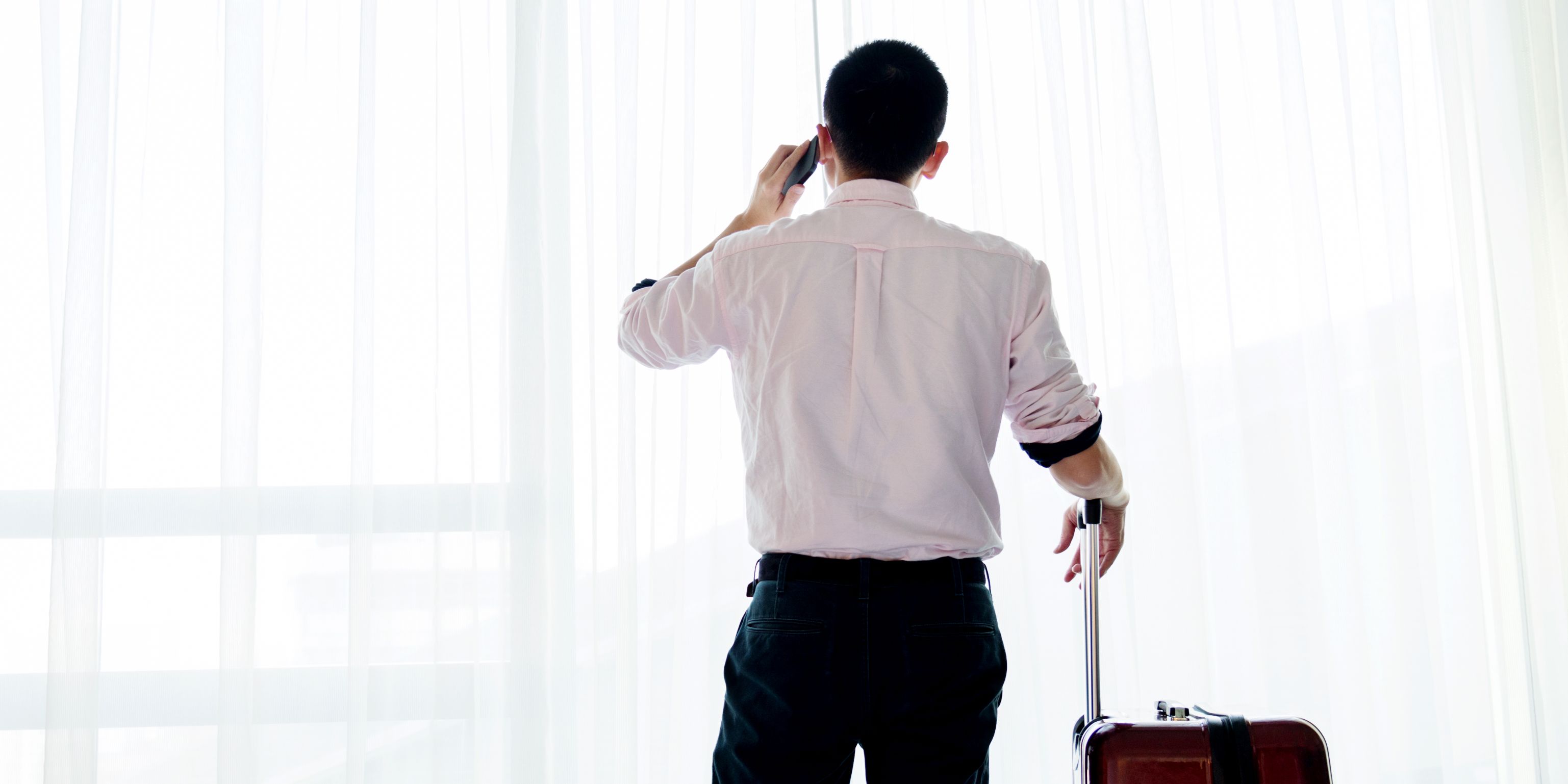 business man talking on phone in hotel room