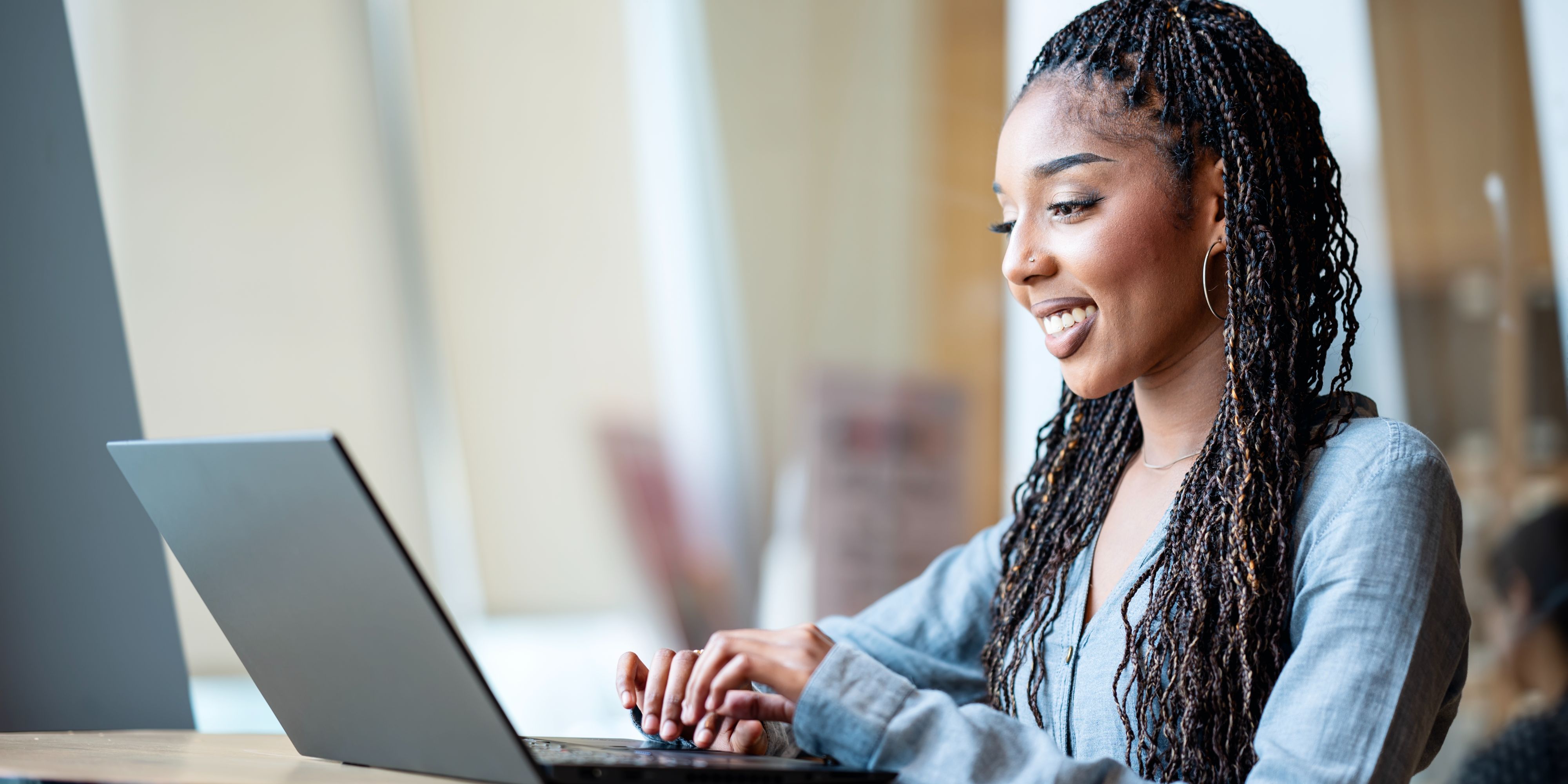 woman working on laptop in hotel