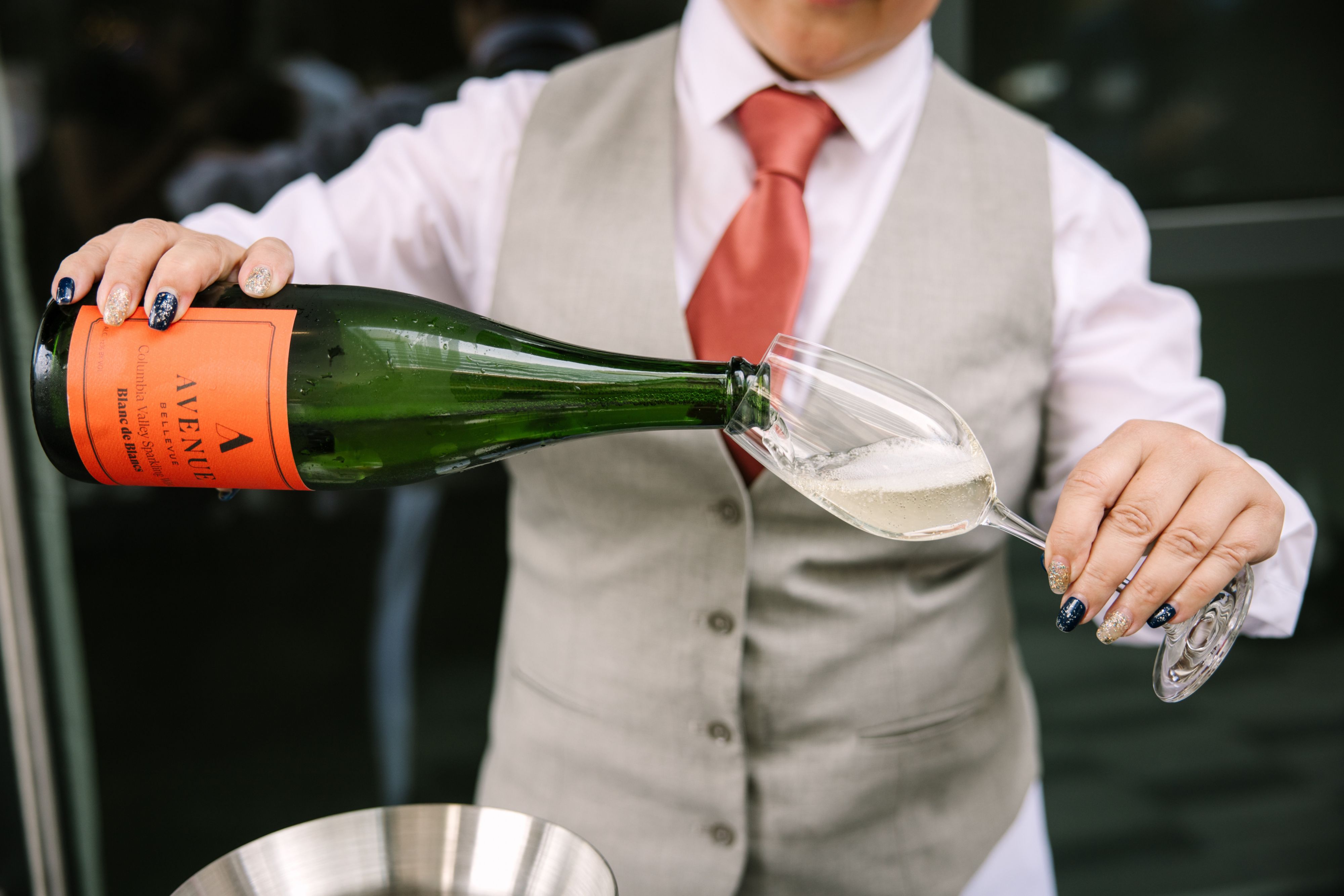 Person pouring champagne into glass