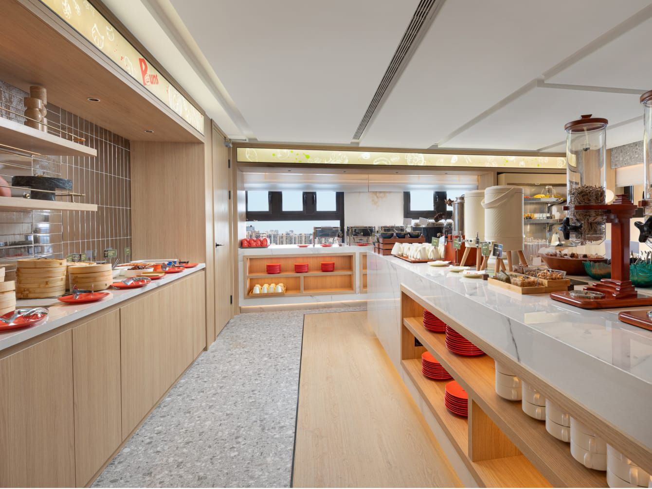 Bright, modern buffet area with counters of dishes and breakfast items.