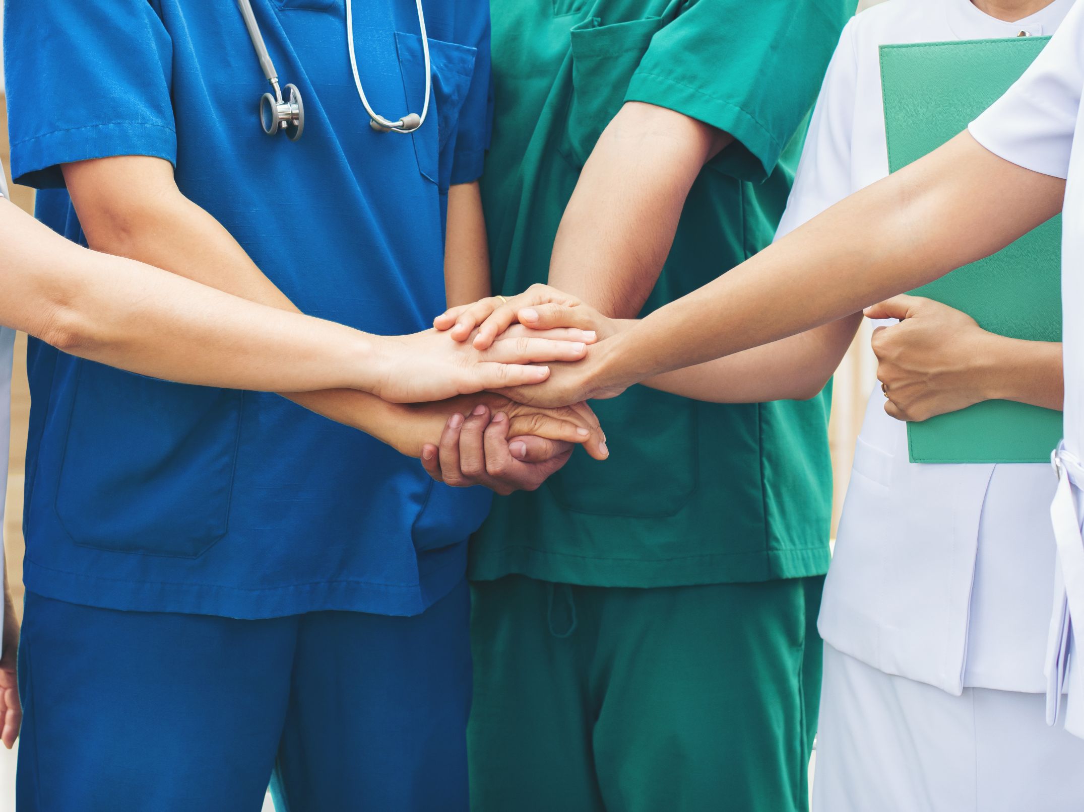 doctors putting their hands together