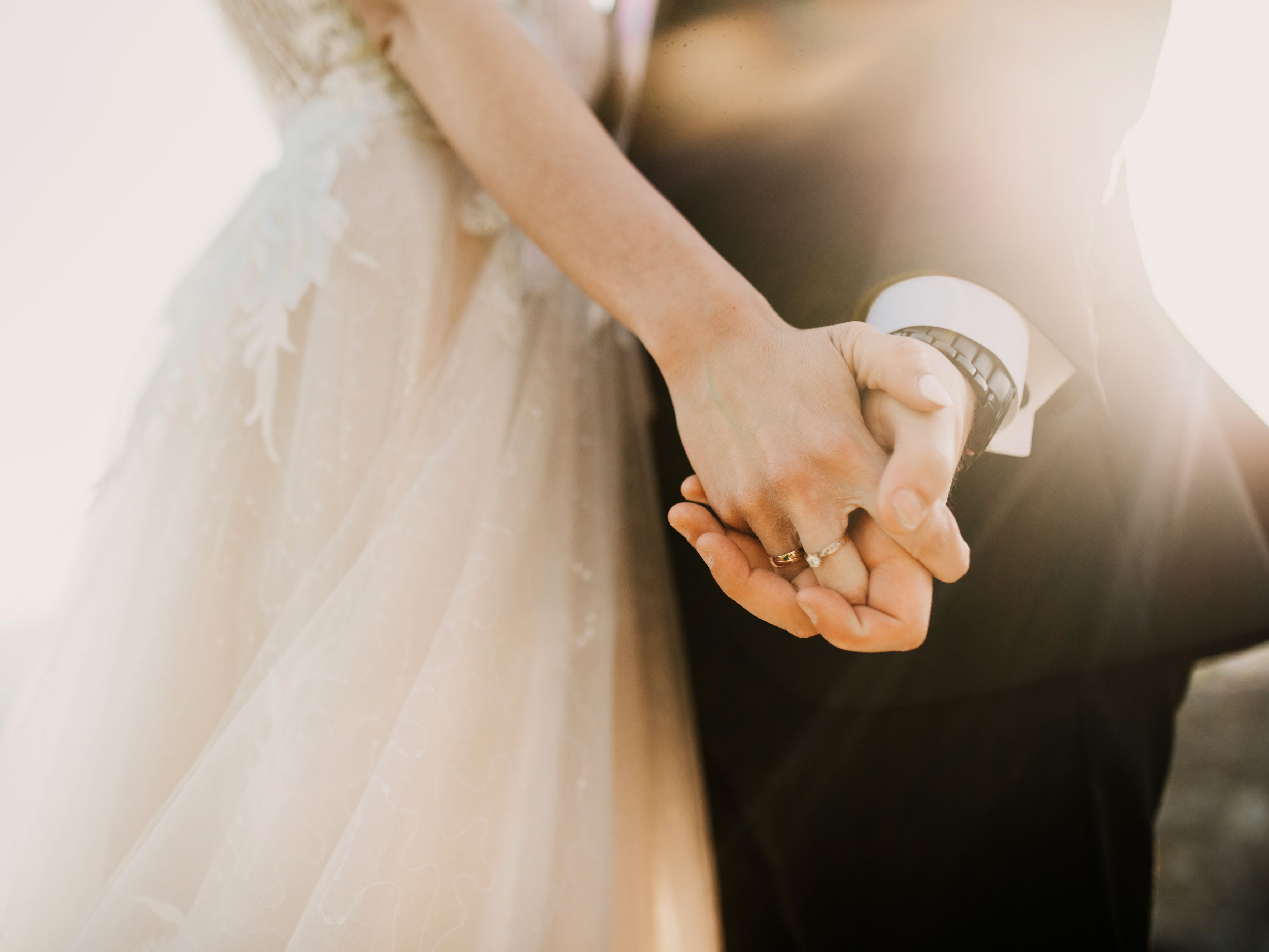 bride and groom holding hands