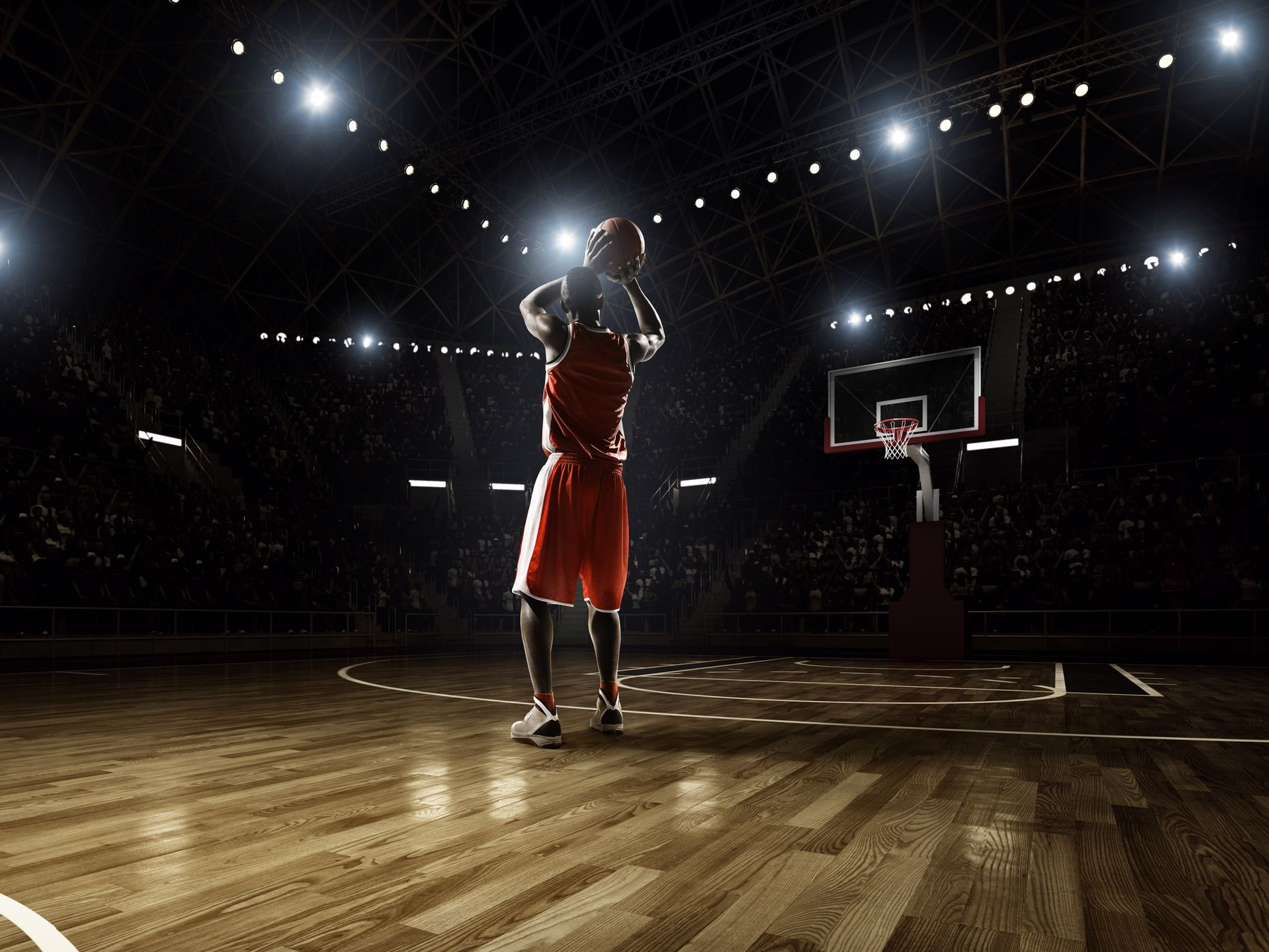 Basketball player taking a shot at the basket.